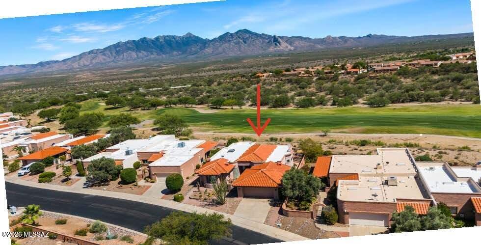 Discover spectacular unobstructed Santa Rita mountain views in this exceptional home located on the 4th fairway of the San Ignacio golf course.  Capture the essence of desert living with a design offering the perfect blend of formal elegance and comfortable everyday living. Flexible spaces can easily be adapted for a home office, media room, or hobby area. A custom gas fireplace creates a warm focal point, while built-in shelving in Bedroom 3 and a Murphy bed in the guest bedroom add convenience and versatility. The updated kitchen flows seamlessly to the inviting outdoor living areas. Step onto the expansive brick patio with its tranquil water feature or relax in the hot tub while enjoying breathtaking night skies and twinkling stars. The VIEWS are simply remarkable! Floor plan included