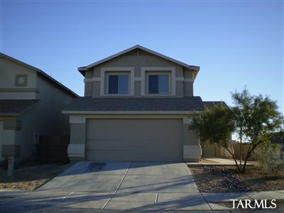 Spacious two-story home located in the desirable Northwest Tucson area. This well-maintained property features 3 bedrooms and 2 full bathrooms upstairs, along with a convenient half bath on the main floor. The primary suite includes a private deck--perfect for relaxing mornings or evening views.
Enjoy a large, fully walled backyard with a covered patio, ideal for outdoor entertaining. Inside, the home offers wood plank flooring on the first floor and comfortable carpeting upstairs. Four ceiling fans provide added comfort throughout. Additional highlights include a full-size washer and dryer, as well as a 2-car garage for ample storage and parking.   Close to shopping, medical facilities, interstate, etc.