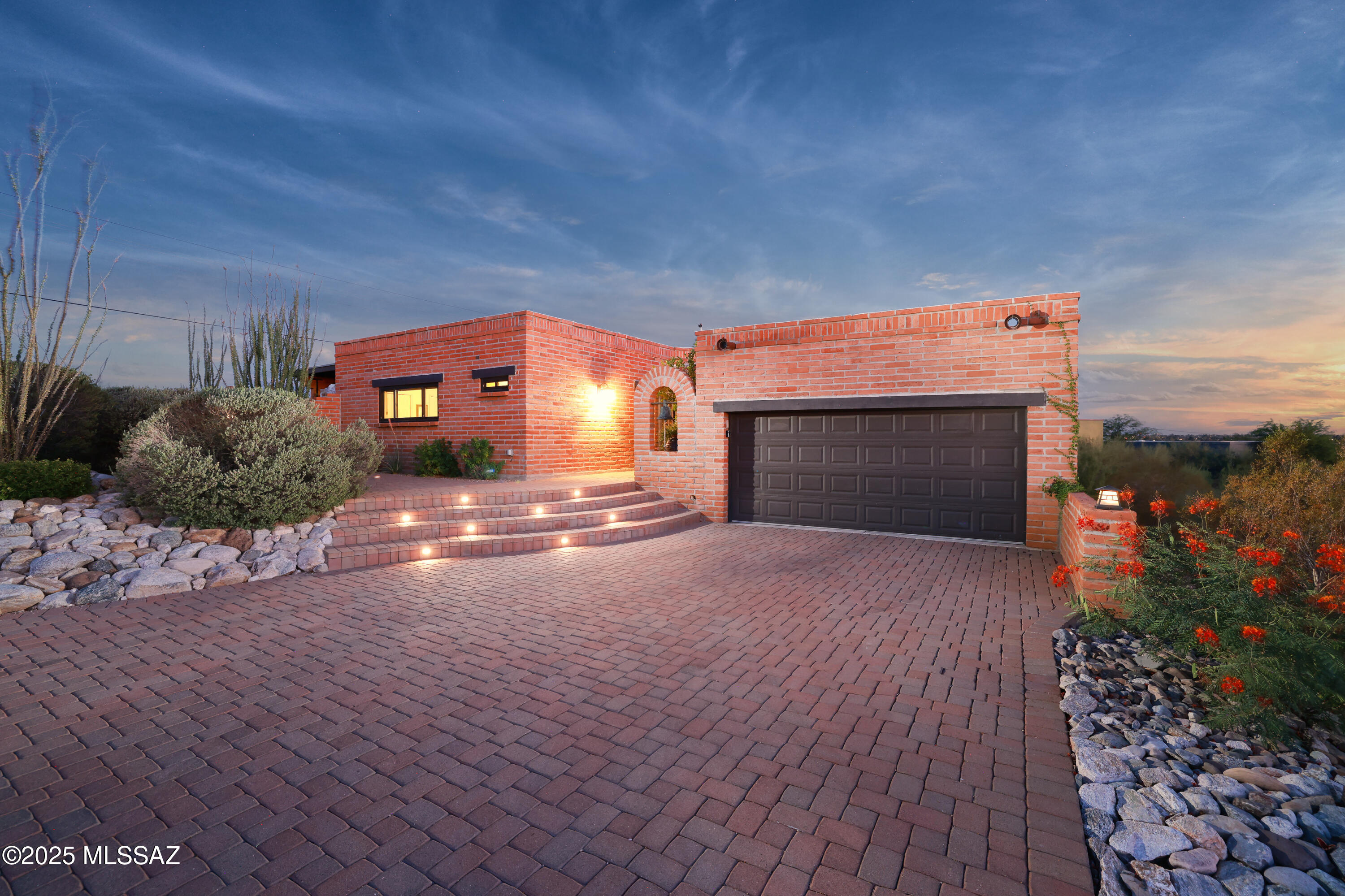 A private driveway delivers you from the end of the cul-de-sac to this ridge-top home with incredible views and an abundance of natural light.  This home has been meticulously maintained, preserving the character of a classic burnt adobe, with a total and complete contemporary remodel in 2017.  Upgrades include: all new kitchen with top-of-the-line appliances, granite counters, custom soft-close cabinets & drawers, 2 beverage fridges, and induction cook top; completely remodeled baths, all new floors, doors, and Anderson windows, HVAC in 2021.  All interior walls re-textured in a contemporary smooth finish in 2024.  Outdoor spaces include an intimate patio with fireplace and sunset views, and a private pool area. The garage features tons of storage & a mini-split HVAC (Sqft not included).