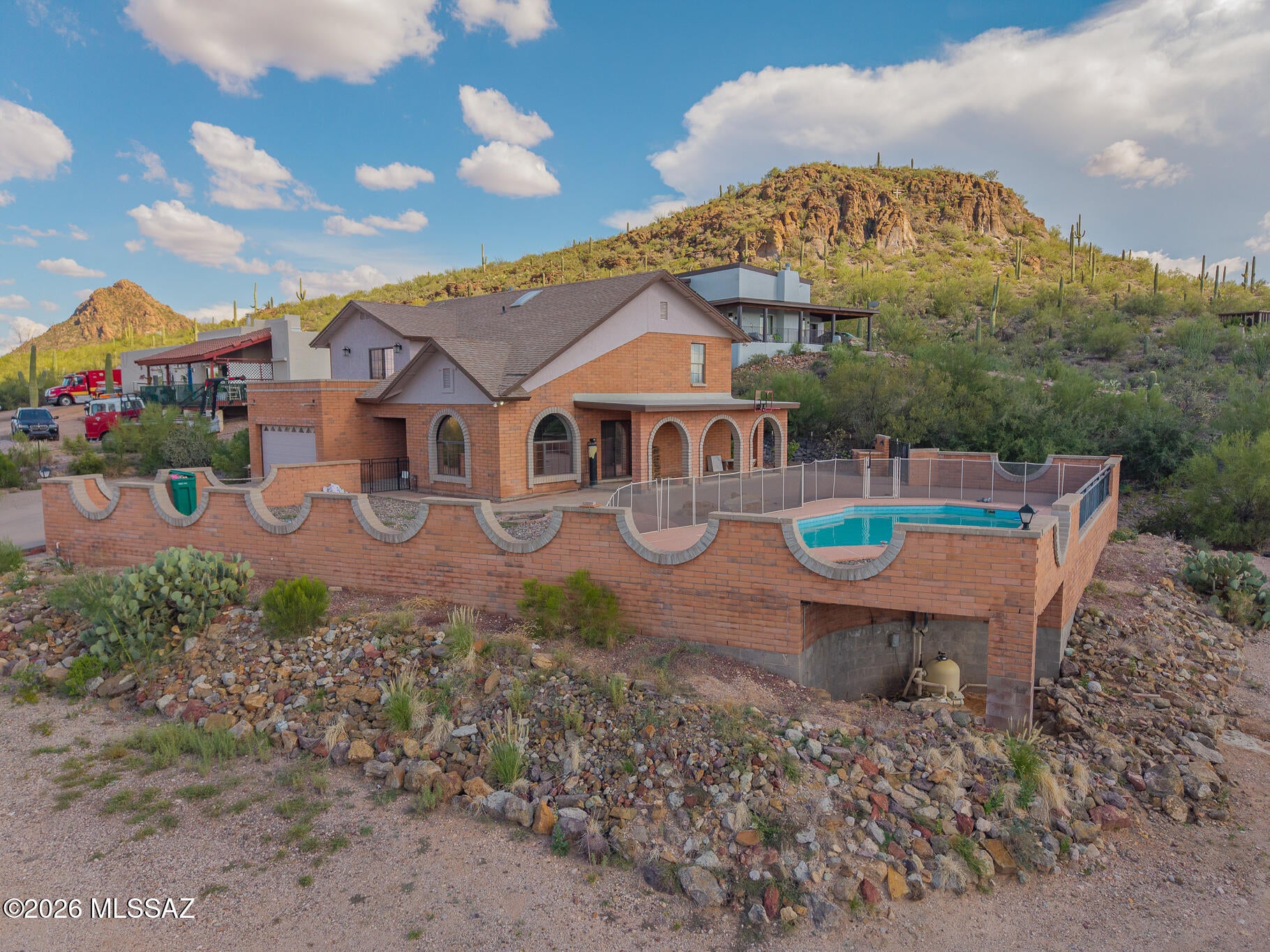 This 4-bedroom, 3-bath home offers spacious living, incredible desert surroundings, and a backyard made for enjoying Arizona living. Step inside to an open and airy layout featuring vaulted ceilings, abundant natural light, updated flooring, and a striking arched picture window showcasing beautiful mountain views. The spacious primary suite includes a double vanity and plenty of room to unwind. Outside, enjoy your own private retreat with a sparkling pool, expansive patio space, and covered outdoor areas perfect for entertaining. The property also features solar panels, a detached garage/workshop, generous outdoor space, and stunning desert and mountain views. A unique property offering space, privacy, and indoor-outdoor living all in one!