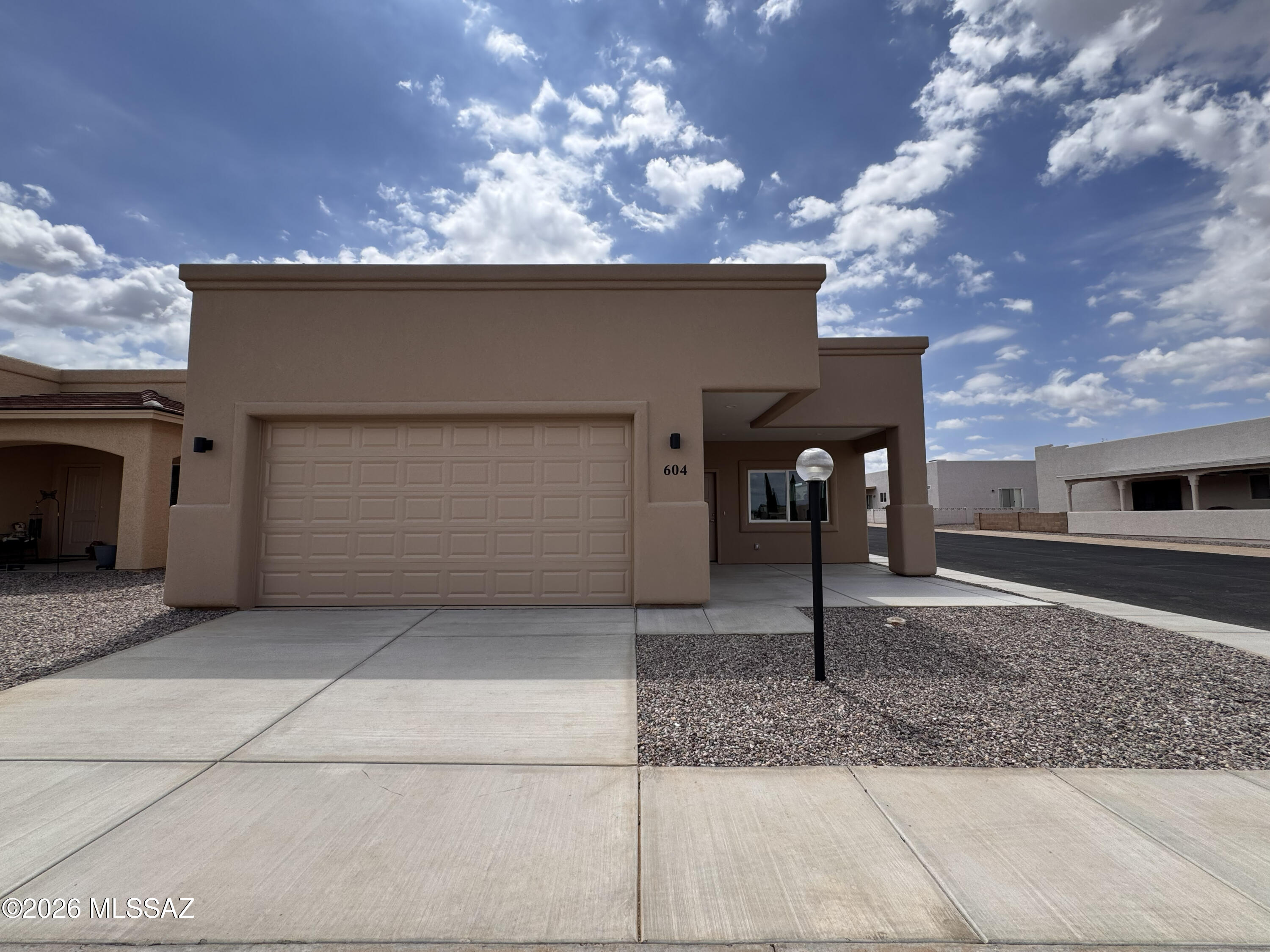 Be the first to enjoy this popular Dakota floor plan on a corner lot in the vibrant 55+ community of Vista View Resort. This thoughtfully designed home offers 3 bedrooms, 2 bathrooms, 1,587 sq. ft., a 2-car garage, and a charming cantilever front porch. The open-concept layout features tile flooring throughout, quartz countertops, skylights, recessed lighting, ceiling fans, 42-inch hallways, and 36-inch doors for added accessibility. Enjoy resort-style amenities including a heated pool and spa, fitness center, pickleball courts, painting classes, movie nights, bingo, card games, potlucks, clubs, dog parks, and EV charging stations. The monthly Resort Fee includes property taxes and trash service, making low-maintenance living easy in one of Sierra Vista's premier active adult communities.
