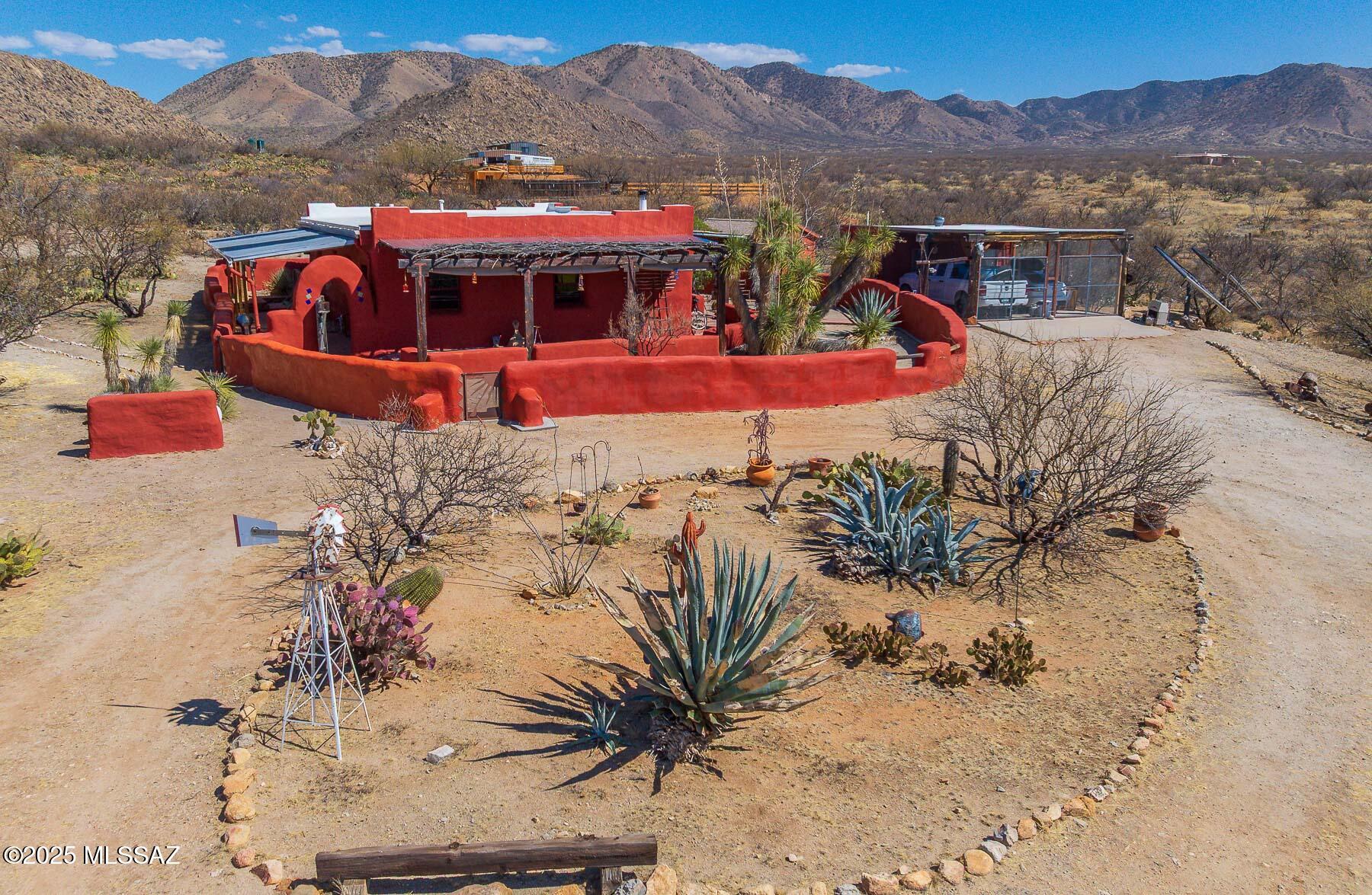 Rare opportunity to own a true off-grid, energy-efficient retreat! This stunning straw bale home features 20-inch-thick stucco-finished walls, providing exceptional insulation. Designed in classic Southwestern style, it boasts soft, rounded corners for a seamless flow between walls, doors, and windows. A newer reflective foam roof enhances efficiency, while the breathtaking valley setting offers panoramic mountain views and pristine desert landscaping. Outdoor adventure awaits in every direction! See images for full home details.  Additional lot available for sale too.  Lot # 301-30-008E.  11.62 acres.  Inquire for details