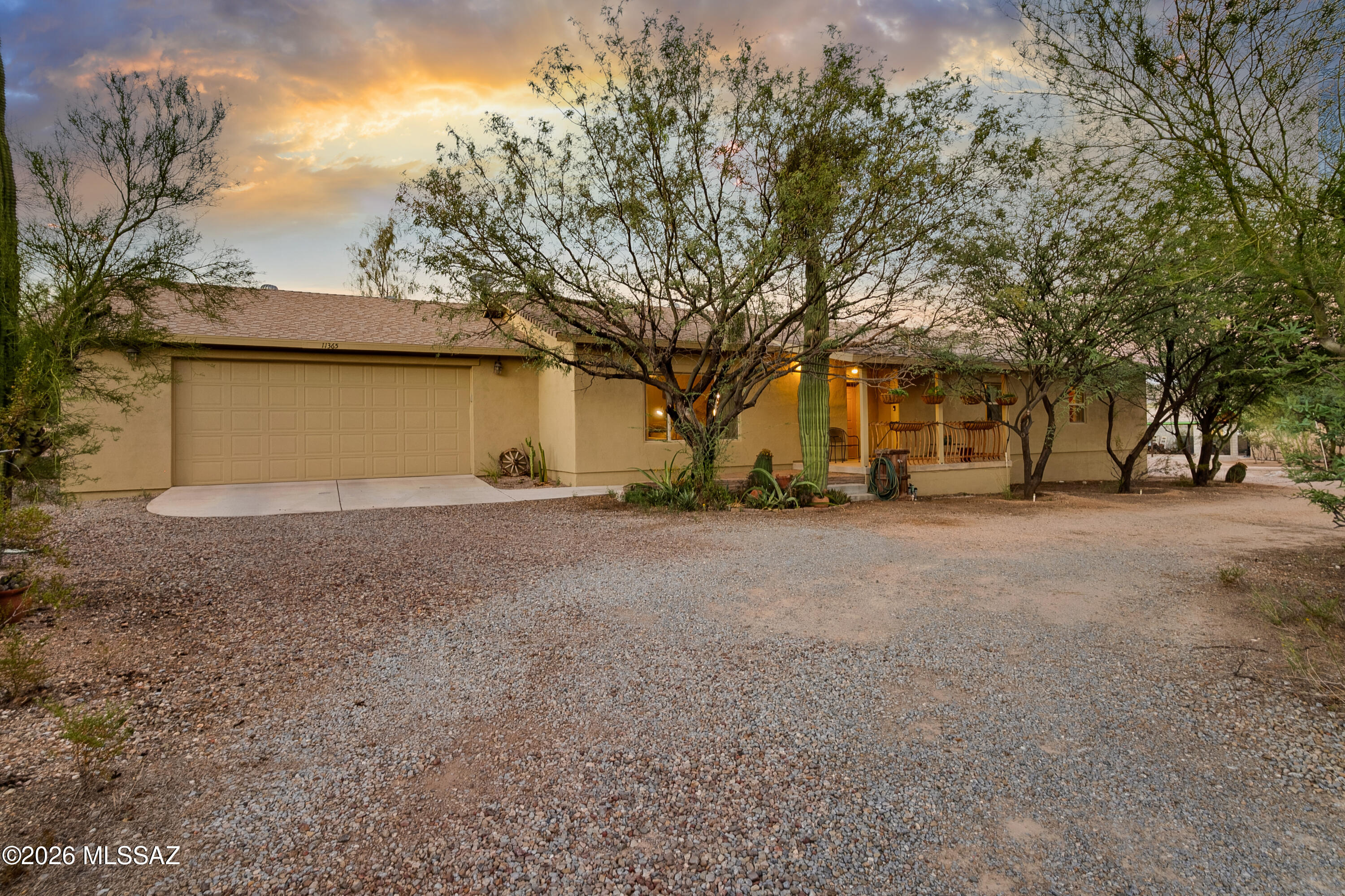 Motivated Sellers!!! Dreaming of a ranch-style compound with space to live, host, and store your toys? This unique property situated on 1 acre of land in the Tanque Verde Valley has it all. Perfect for multigenerational living, guests, or rental income, the property includes a main house with guest quarters plus a free-standing casita with a full kitchen and bathroom, dog run, and front and back porches. Outside, there's serious room for vehicles and gear: an extended 2-car garage with built-ins, overhead storage, and 400-amp panel wired for two EV chargers, a ramada that can double as a 3-car carport, 2 uncovered spaces, 2 shipping containers, a shed, and a spot to set up an RV dump hookup. For those who've dreamed of a small-scale homestead, you'll find a greenhouse with water and electric, citrus and pomegranate trees, rainwater and greywater harvesting that feeds the front and back irrigation, an outdoor industrial steel sink with counter space, and a chicken coop.

Inside the main house you'll discover scored concrete floors throughout, high ceilings, and a welcoming foyer with oversized rustic oak doors that open to the living area. In addition to the 3 bedrooms and 2 full baths, a separate guest quarters with full bathroom and mini-split can be accessed from the back porch or through the garage. The primary suite boasts a huge custom walk-in closet, extended-height vanity with granite, and French doors that open directly to the 70' covered back porch and hot tub. The roomy kitchen features an oversized porcelain farmhouse sink, newer appliances, stainless range hood, breakfast bar, and tons of storage with space for an island or large dining table.
Recent updates bring peace of mind: roof inspected and repaired (2025), fresh exterior paint (2025), newer water heater (2024), newer HVAC (2022), plus smart door entry for both the main and guest houses as well as double-thick 12" exterior walls with extra insulation. All this just a short walk to schools and Agua Caliente Park, minutes to some of Tucson's best hiking, and an easy escape to Rose Canyon Lake and Summerhaven.