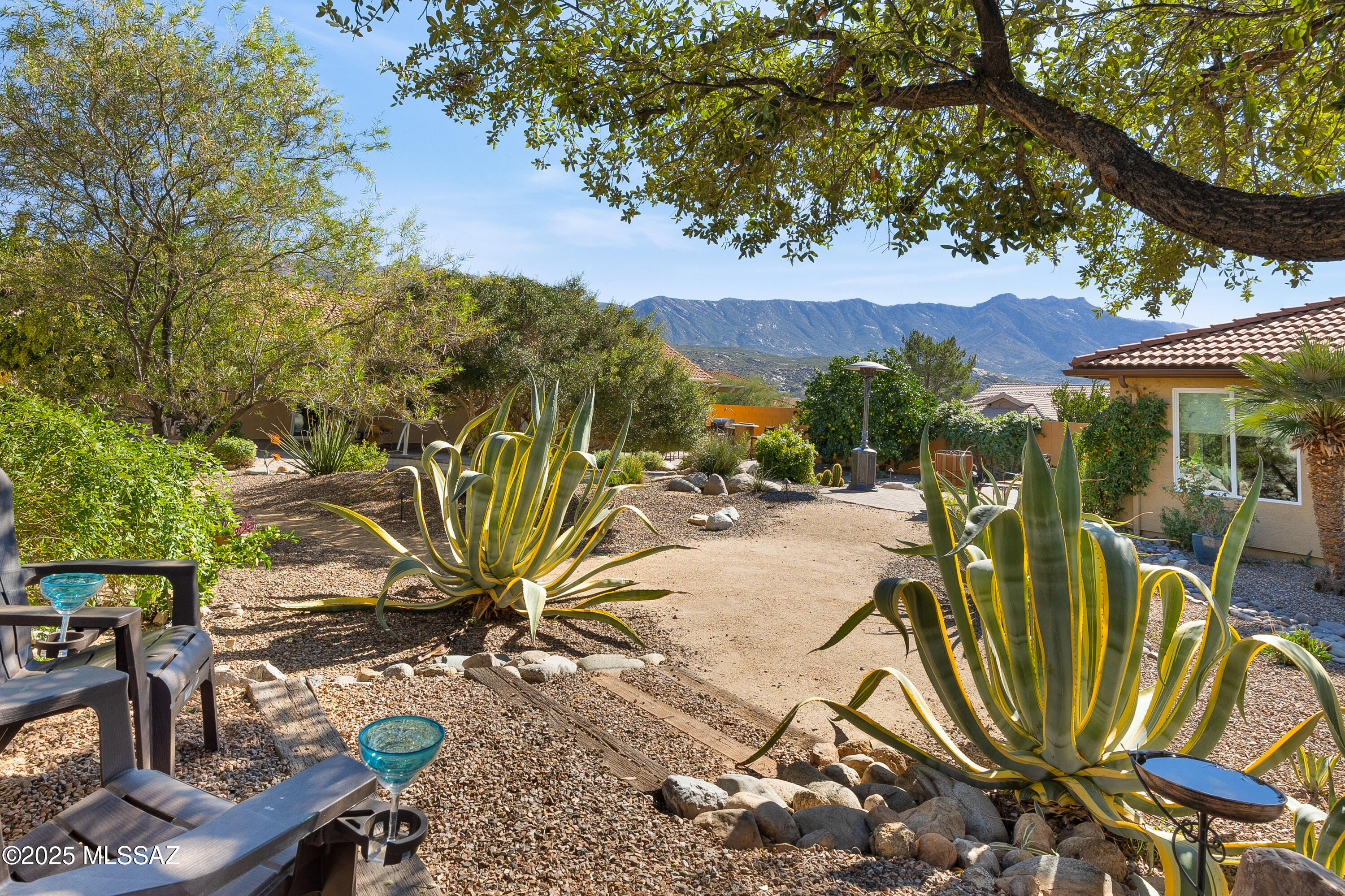 Stunning and distinctive, this extensively remodeled 3BR/3BA + Bonus Rm 2.5 garage Home, complete with 452 sq ft GUEST HOUSE has been reimagined with a custom floor-plan redesign that enhances flow, natural light, and daily functionality.Corner lot with superb curb appeal & extra-deep yard delivers resort-level living & mountain views. Backyard feels like a private retreat featuring one of SaddleBrooke's most impressive pools-lap length natural lagoon design w/waterfall, lush landscaping, citrus trees & multiple seating areas. Open-concept main house offers porcelain wood-look tile (no carpet), all new windows/doors incl. French doors, solid alder interior doors & designer kitchen w/4x8 quartz island, gas cooktop, double oven & abundant smart storage. Primary suite w/double-door entry, ensuitseparate vanities, tiled shower & walk-in closet. Front bonus room with pocket door framed by moutain views for office, den, studio or guest space. Perched above the pool, the furnished 452 sq. ft. guest house offers a living and dining area, kitchenette, bedroom, and bath--an ideal, boutique-style guest retreat. Preinspected and repairs completed--the property is move-in ready. Come enjoy all that SaddleBrooke has to offer: championship golf, resort-style pools, fitness centers, pickleball and tennis, on-site restaurants, and over 100 clubs and social groups. Set against the Santa Catalina Mountains, SaddleBrooke delivers an active-adult (ownership availabe 40+) lifestyle unlike any other--where every day feels like a vacation.