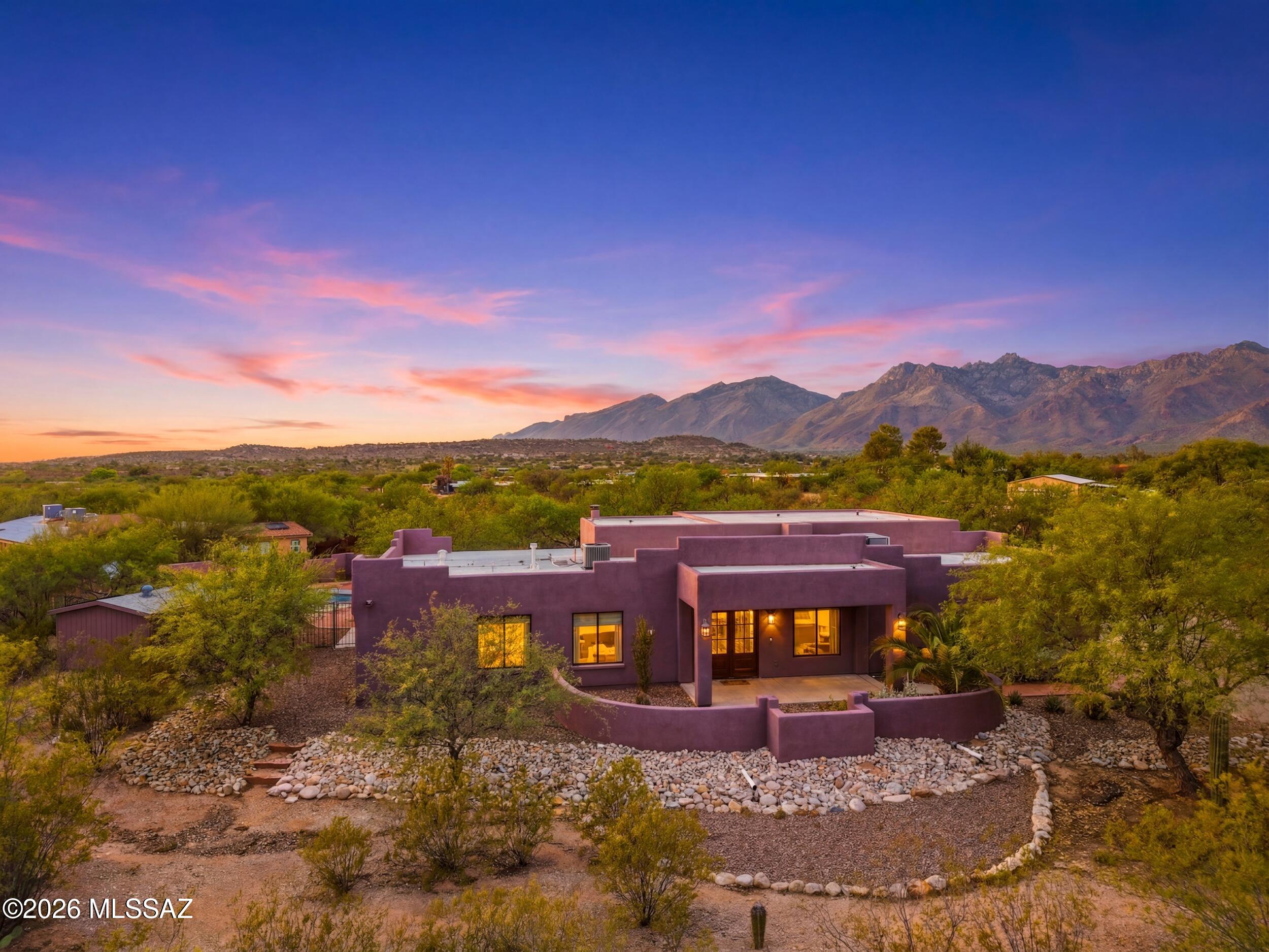 Experience refined desert living at its finest in this completely renovated Tucson retreat, where every finish has been curated to create a home that feels both elevated and effortless. The interiors feature timeless travertine flooring, leathered granite in the kitchen, stainless steel appliances, a large island, walk-in pantry, and an elegant wet bar, all complemented by a double-door entry that sets the tone for the residence. A spectacular laundry room offers exceptional storage and a sink, while the thoughtfully designed split layout includes a bedroom set apart from the rest--ideal for a private home office, guest suite, or flexible bonus space. The primary suite is a true sanctuary with private backyard access, soaking tub, walk-in shower, dual vanities, and generous walk-in closet, and the secondary bedrooms are notably spacious and comfortable. Outside, 1.17 acres of serene desert beauty deliver a pool, spa, covered patio, artificial turf, RV parking, and additional land ready for your vision, all framed by absolutely STUNNING mountain views that define Tucson living. Close by, you'll find plenty of shopping, restaurants and right down the road from Mt. Lemmon Highway that takes you to the iconic Summerhaven in the cool pines of Mt Lemmon. This home is truly a dream!