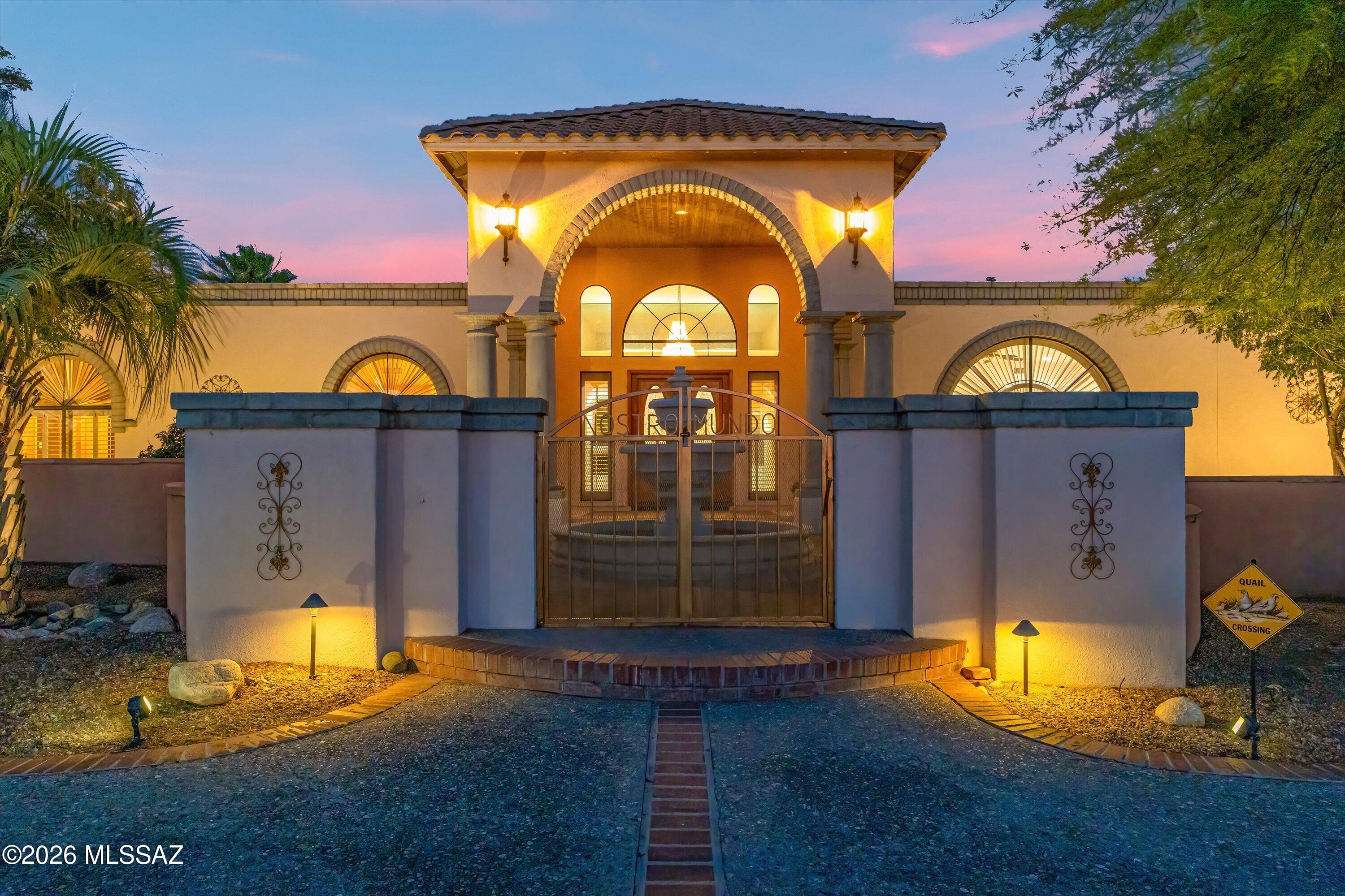 Your Own Private World in the Desert! Set on 8.05 acres, this exceptional estate offers privacy, scale, and versatility--now with a more open, intentional landscape that highlights the home and surrounding mountain views. Enter through the gated drive and experience a property that has been thoughtfully refined. The vegetation has been selectively reduced to create cleaner sightlines, bringing the architecture forward while enhancing natural light and long-range views. The 5,102 sq ft custom masonry home with metal interior framing delivers both durability and thoughtful design. Inside, you'll find 5 bedrooms (including flexible gym/office spaces) and 5 bathrooms, plus a dedicated exterior pool bath. The expansive great room with 12' ceilings connects seamlessly to a well-appointed kitchen featuring granite countertops, a large island with wine fridge, and premium appliances including Viking range/ovens and Sub-Zero refrigeration.
Additional living spaces include a formal dining room and a spacious game/rec room with built-ins, wet bar, and beverage refrigerator--ideal for entertaining.
Outdoors, the property is designed for enjoyment without excess upkeep. The backyard features a pebble tec saltwater pool and spa, extended covered patio, outdoor kitchen, gazebo, and half-court basketball area. A dedicated pet space with direct access from the primary suite adds everyday convenience.
The 765 sq ft detached guest villa offers a full 1 bed / 1 bath layout with kitchen, quality finishes, and a private courtyard complete with fire pit, BBQ area, and covered seating. A spiral staircase leads to a rooftop deck with sweeping sunset and mountain views.
For those needing space for vehicles, equipment, or hobbies, the property includes a 3-car attached garage plus a separate 4-car/RV garage and workshop equipped with a car lift and air compressor. 
A rare combination of scale, function, and refined presentation ready for you!
