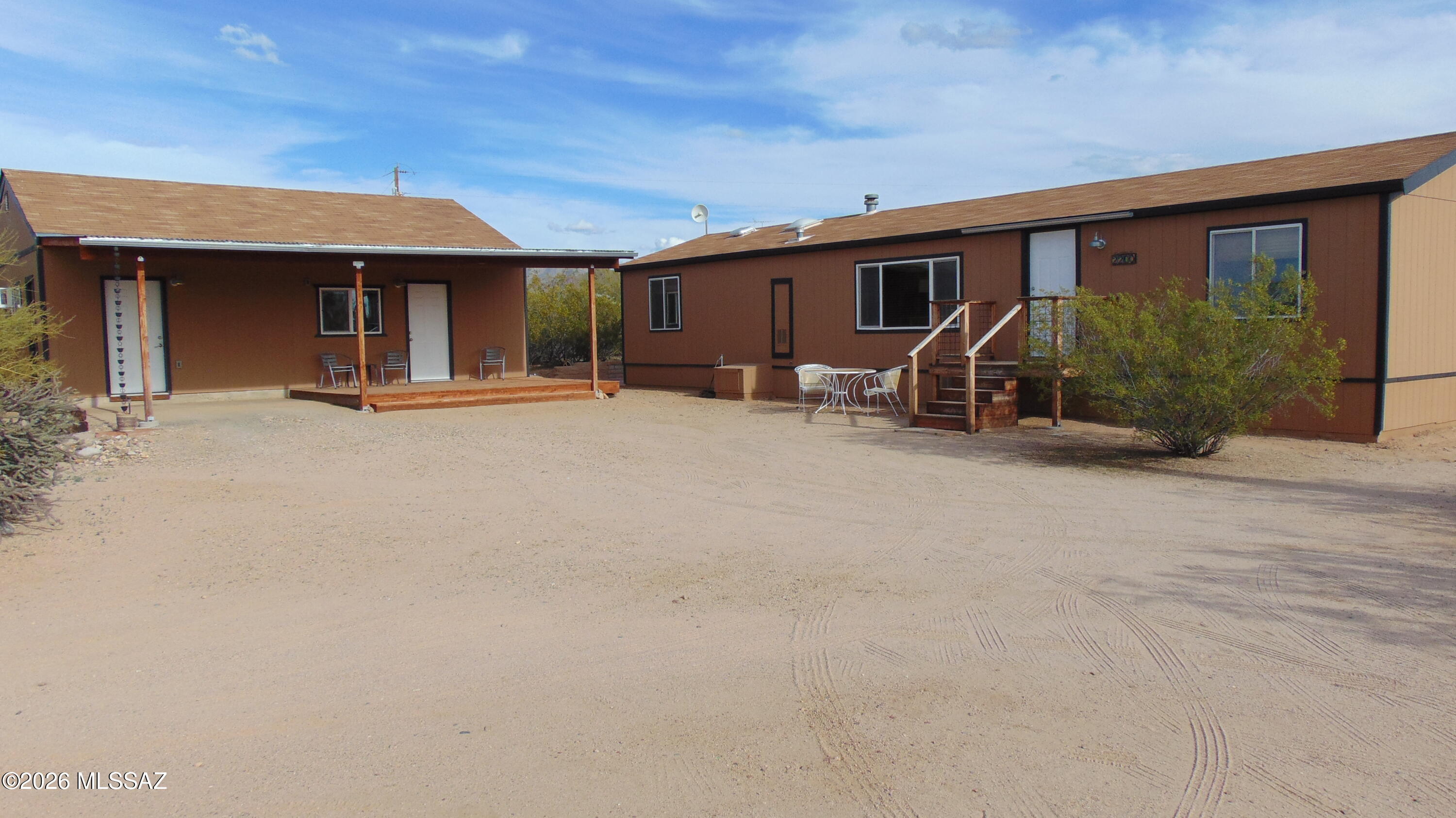 Wonderfully maintained affixed Shulte manufactured home on a quiet secluded acre at a dead end road.  Detached building with bonus room and shop. Could be lounge, art/music studio or work space.  Whole building with shop is 720 square feet per assessor. Ductless cooling/heat for the bonus room that is approximately 500 square feet. Manufactured home has updated windows and custom cabinets in kitchen. Two full baths, split bedroom floor plan. Laundry room with storage. Stunning mountain views to the East and West with amazing sunsets, views to Kitt Peak. Short drive to Arizona-Sonoran Desert Museum and ample hiking and picnic area's in the Saguaro National Park West.