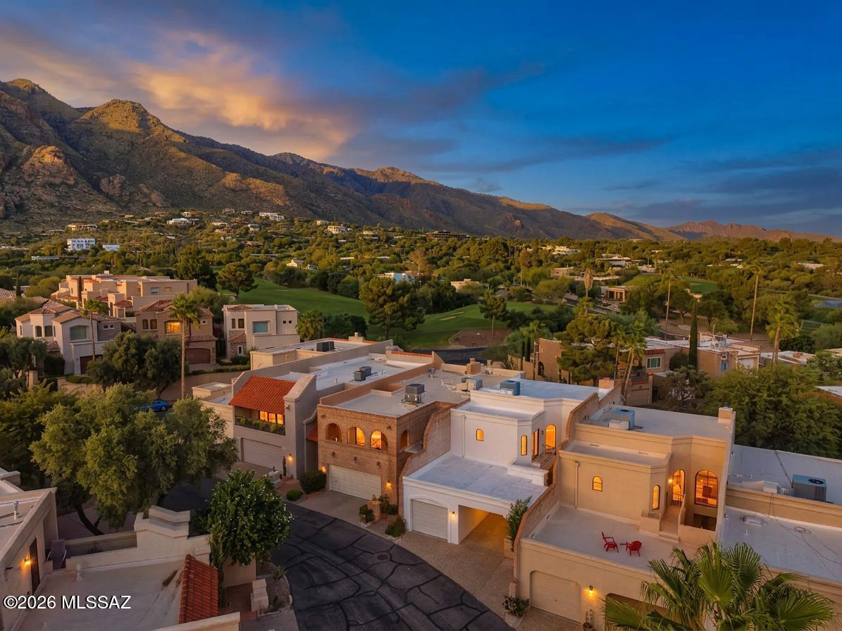 Amazing opportunity for updated 3 bed/2.5 bath, 1,818 SqFt, split floor plan, all electric masonry stucco townhome with attached 471 SqFt finished garage and carport, on low maintenance lot, omnipresent panoramic Catalina Mountain views, in the desirable gated golf community of Skyline Country Club located in the vaunted Catalina Foothills school district in North Tucson.
Experience the coveted Skyline Country Club lifestyle, where country club living meets exceptional value. An appealing opportunity for those seeking the amenities, ambiance, location and lifestyle of a premier golf community at an affordable price.
Featuring E/W orientation, aggregate concrete driveway, concrete sidewalks, additional guest parking and community pool. Inside enjoy soaring textured cathedral ceilings (no popcorn), energy efficient double pane windows throughout, matching energy efficient double pane sliding patio doors X3, custom curtains, added modern LED recessed lighting throughout, luxury ceramic plank tile flooring with plush carpet on stairs and bedrooms, convenient downstairs bedroom with slider out to covered patio and bathroom, downstairs internal laundry access w/exhaust fan, matching white GE Smart washer & dryer included, new HVAC 2023, Honeywell Pro Series digital thermostat, alarm system with Smart panel, doorbell security camera, skylights, copper and Pex plumbing, updated electrical outlets, matching modern black luminated ceiling fans, matching modern black hardware and fixtures, spacious living room features wood burning masonry fireplace and expansive picture windows create a fantastic ambiance while filling the home with abundant natural light.
Cozy remodeled kitchen with full slab quartz countertops, bar seating, crisp white modern kitchen cabinets, stainless steel appliance package, electric stove, built-in microwave, large metal sink w/garbage disposal, stainless steel side-by-side fridge w/water and ice dispenser, custom subway tile backsplash, suspended metal hanging pot rack, closet pantry, adjacent to breakfast space, conveniently located next to attached finished garage with additional storage. Ascend the sweeping carpeted spiral staircase to second story sizeable bedrooms each with their own ensuite updated full bathrooms, perfect solution for those seeking two primary bedrooms, including massive primary suite with private ensuite full bathroom complete with dual sink quartz countertop modern vanity, walk-in tiled glass shower, energy efficient double pane slider to covered balcony for daily breathtaking Catalina mountain and fresh green grass golf course views!! Enjoy tranquil Tucson nights under your covered patio space, low care backyard, surrounded by masonry block privacy walls. 
Priced below the $571,800 RVM property value report, call to make your appointment to view this updated home today!!