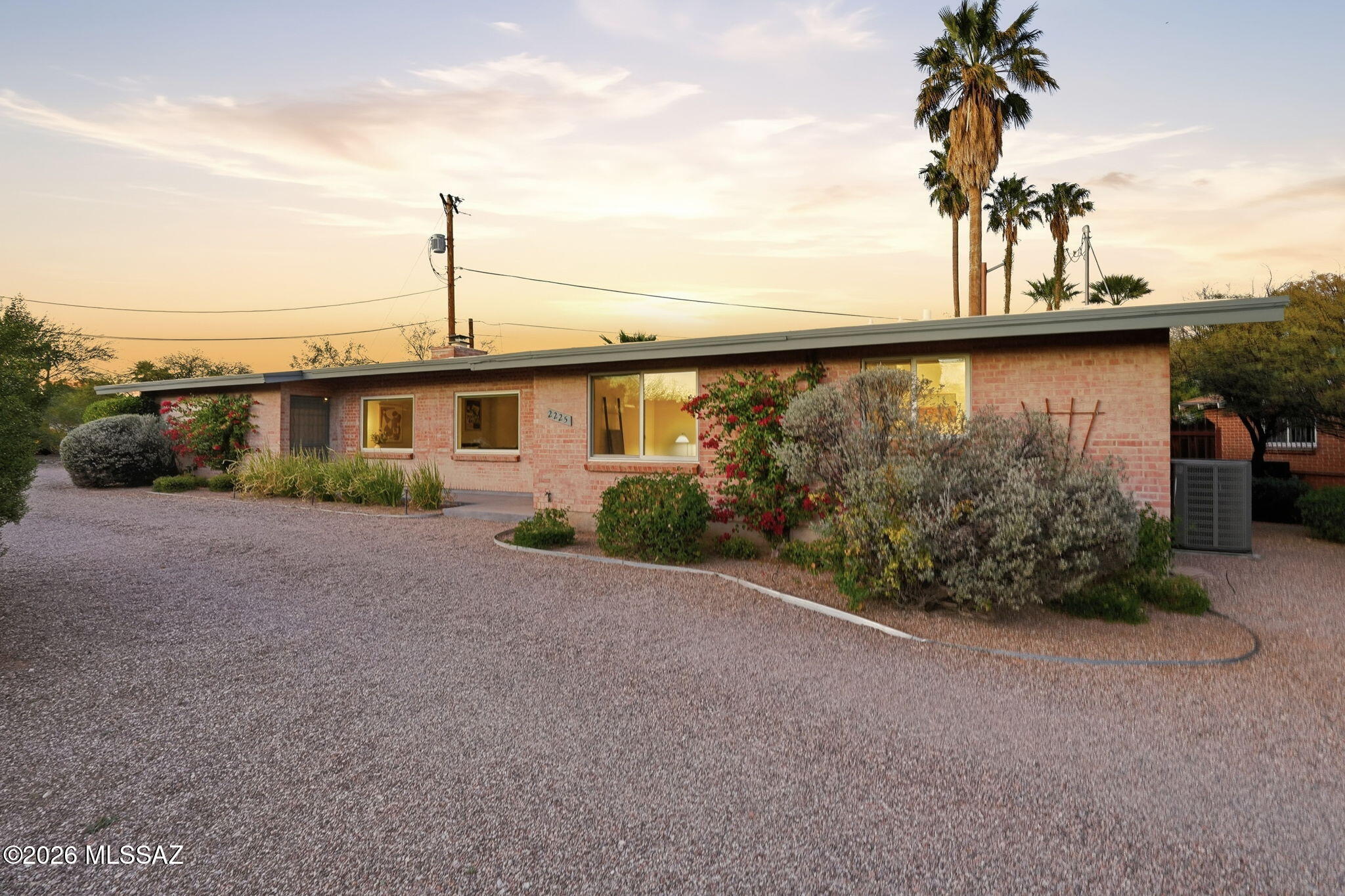 Rare Mid-Century Modern home in Historic Catalina Vista, designed by Arizona's pioneering female architect, Anne Rysdale. This 2BR/2BA gem blends architectural pedigree with sophisticated modern luxury. Interior features signature beamed ceilings, terrazzo tile flooring, and an elegant gas fireplace. The home has been thoughtfully updated for efficiency with dual-paned windows throughout. A true chef's kitchen awaits, anchored by a La Cornue range, custom oak cabinetry, and seamless MCM touches. The primary bedroom and living areas flow effortlessly to a private backyard. Enjoy the covered patio, lush low-maintenance turf, and mature desert landscaping. Two-car garage provides ample storage. Minutes from the University of Arizona, Banner Medical and Campbell corridor ammenities.