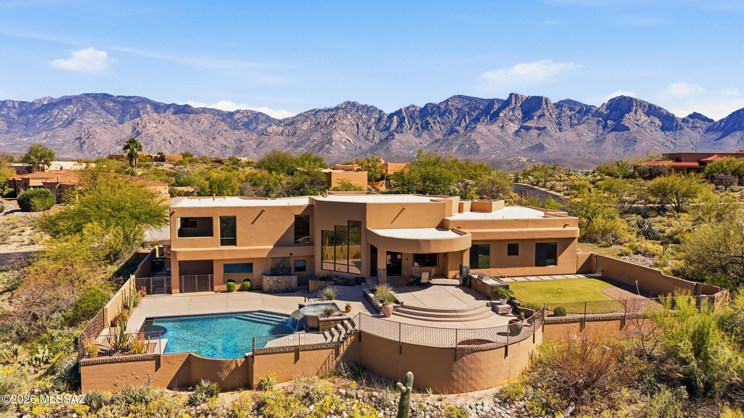 Private Gated Custom Residence on 1.19 Acres with Mountain views. Open floorplan, oversize 3-car garage, floor-to-ceiling windows, waterfall entry, & travertine floors. The backyard features a pool & spa, a built-in BBQ, an outdoor shower, a firepit, grass, and covered patios. Recent upgrades include new paint, slate, light fixtures inside and out, smart home lighting and sprinkler system, new flooring in the master and garage, new water softener & gas water heater. 6th bedroom is small, close to the master and would be a great nursery.