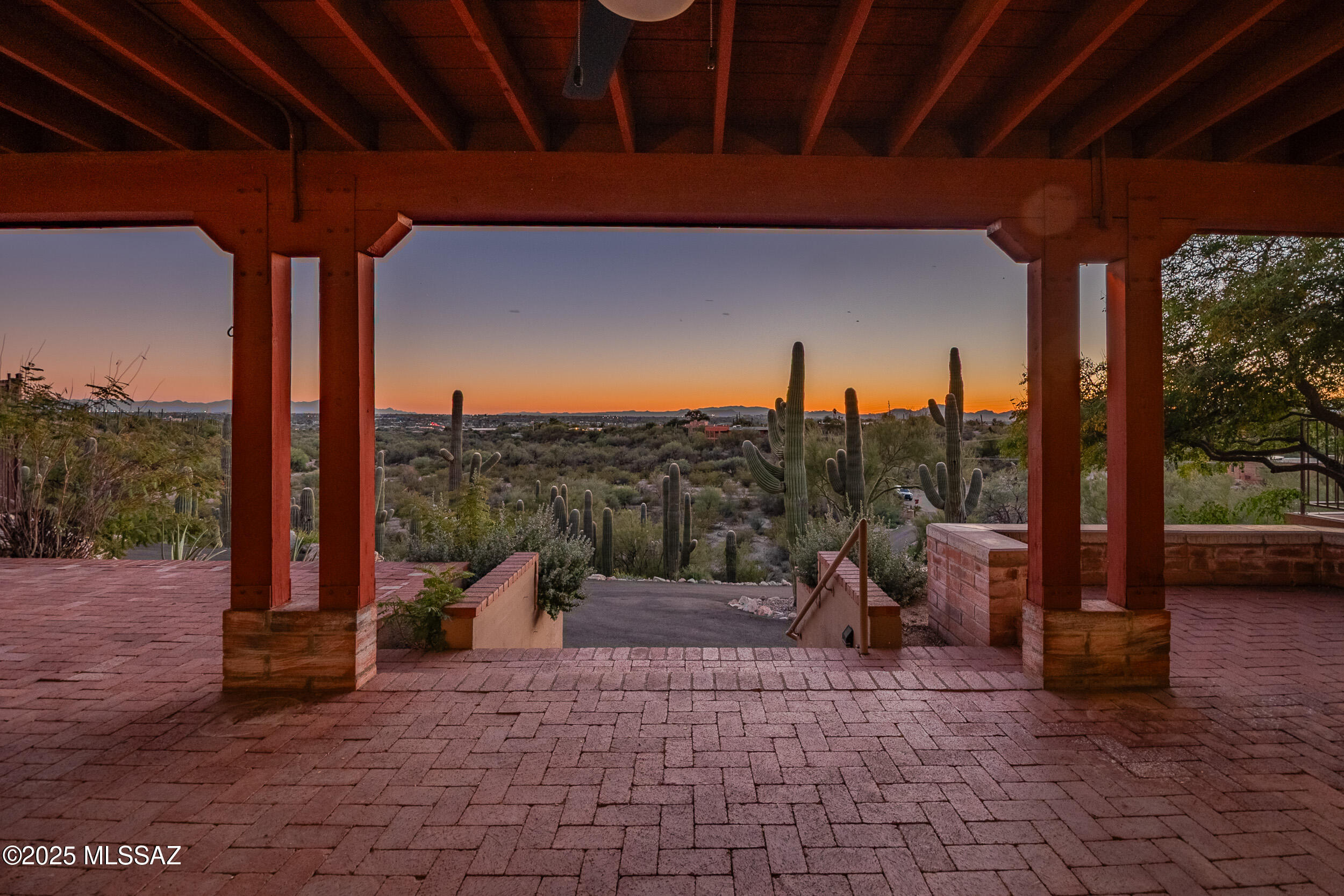 Perched at the top of 3.44 divisible acres with an impressive saguaro cactus grove along the hillside, this burnt adobe masonry home offers magnificent sunrise, sunset, city, and mountain views. This property features 2,106 square feet of living area with 3-bedrooms and 2-full-bathrooms, a spacious kitchen that opens onto the family room and the beehive fireplace. The separate living room and formal dining offer breathtaking views of the Tucson valley and the mountains beyond. A sprawling outdoor living space spans the full length of the home and offers covered patio, open deck, and a beautiful fenced-in pool.