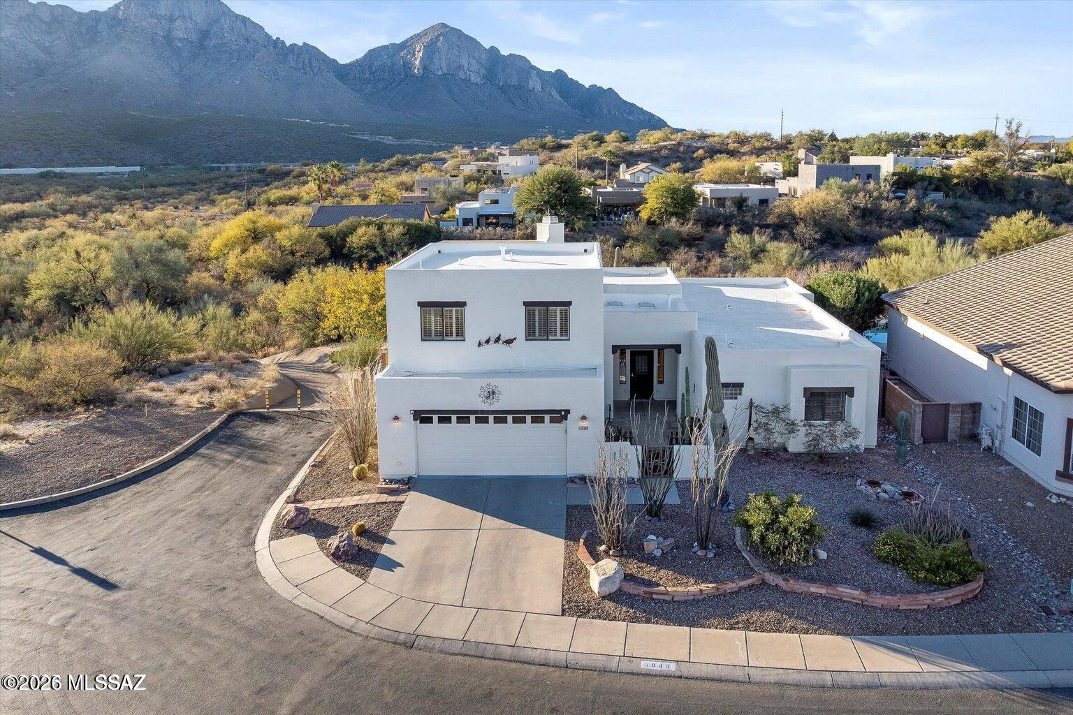 SSUMABLE VA LOAN AT 5.5%! Stunning Southwestern-style residence nestled in the heart of Oro Valley. This exquisite home offers a harmonious blend of traditional charm and modern amenities, all set against the breathtaking backdrop of the Santa Catalina Mountains. The expansive great room features a cathedral ceiling adorned with wooden beams, custom shelving, and an inviting beehive fireplace, creating a warm and welcoming atmosphere. Culinary enthusiasts will appreciate the granite countertops, gas stove, glass-faced cabinets, and a bay window that frames picturesque mountain views. 
Be aware tenant are still in place until April 30th, 
NO Entering property grounds other then during scheduled open houses until Vacent.