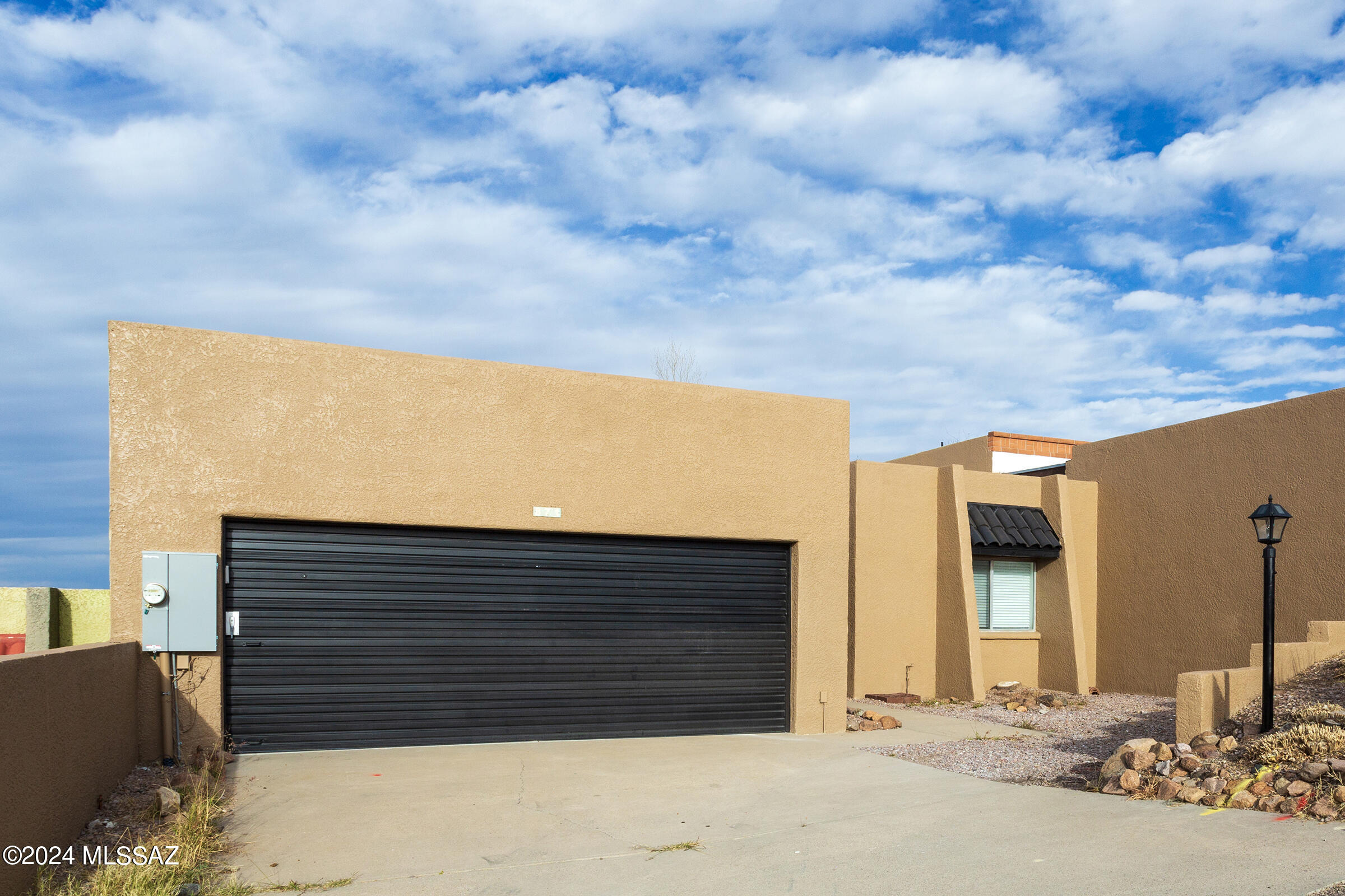 This beautiful RENTAL is located in Nogales in Rancho Grande off of Patagonia Hwy. This  remodeled townhome truly offers modern comfort throughout. The open concept living & dining area features skylights, a cozy wood-burning fireplace, recessed lighting, abundant natural light, interior paint, tile flooring throughout & ceiling fans with remotes creating a warm & inviting atmosphere. The kitchen showcases modern appliances, ample wood cabinetry & elegant quartz countertops. A spacious 2 car garage includes a full wall of built-in wooden cabinetry for exceptional storage. The living room's French doors open to a covered patio and an enclosed backyard. Schedule your showing today!