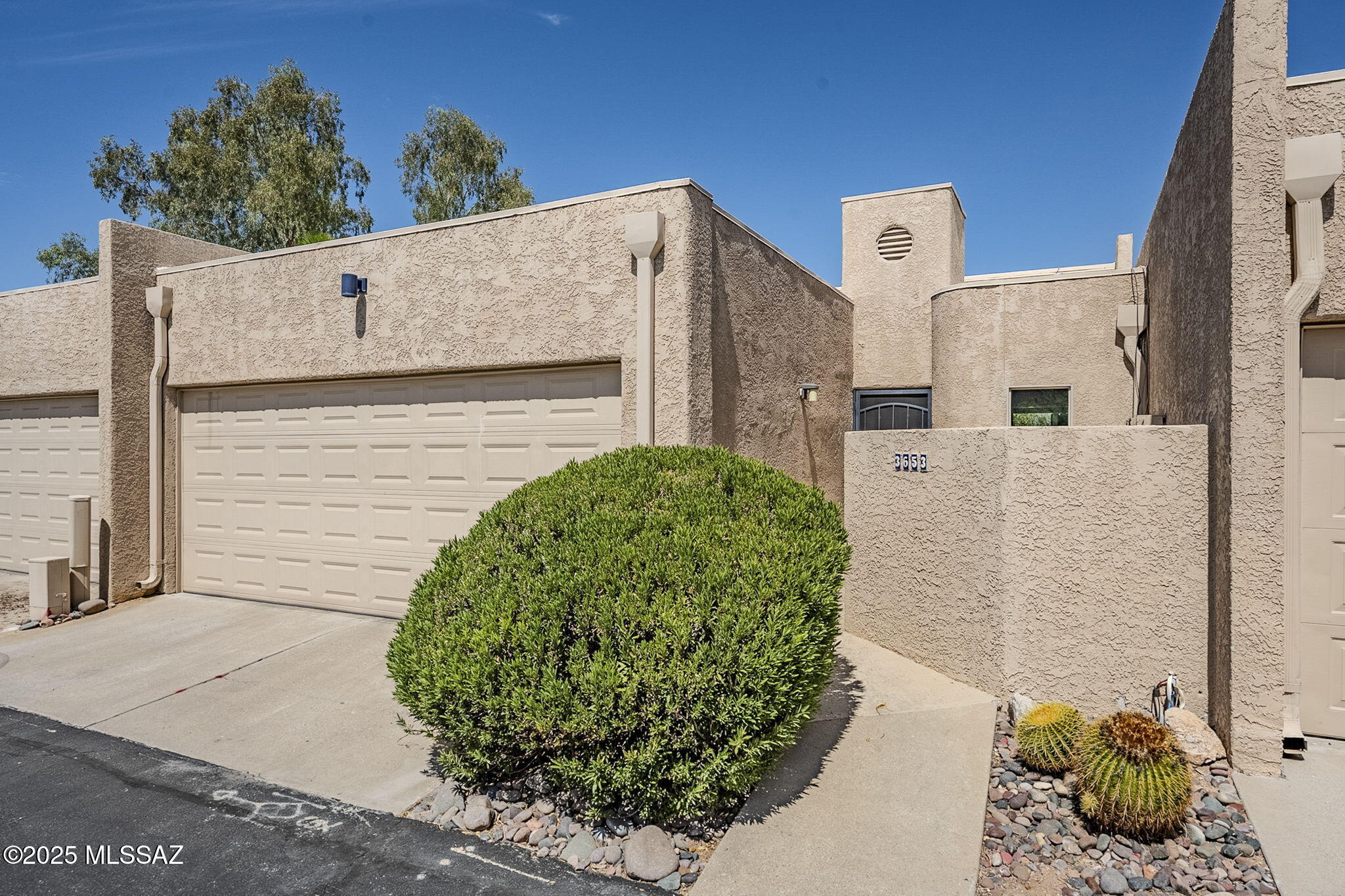 Privately situated at the end of a peaceful street, this 2 bed/2 bath townhome offers charm & convenience in central Tucson. The living room centers around a magnificent wood-burning fireplace-an architectural focal point. Vaulted ceilings, skylights & picturesque dual pane windows fill the home w/ natural light. The remodeled kitchen (2019) offers granite counters, stainless appliances, a center island, abundant cabinetry including a huge pantry cabinet & conveniently located front-load washer and dryer. The primary bath was refreshed in 2025 & the roof recoated in early 2025.  Unwind in the spacious backyard, complete w/ artificial turf & an expansive paver patio. HOA covers water, sewer & trash. Near Riverwalk, Tucson Racquet Club & St. Philip's Plaza. Short-term rentals allowed!