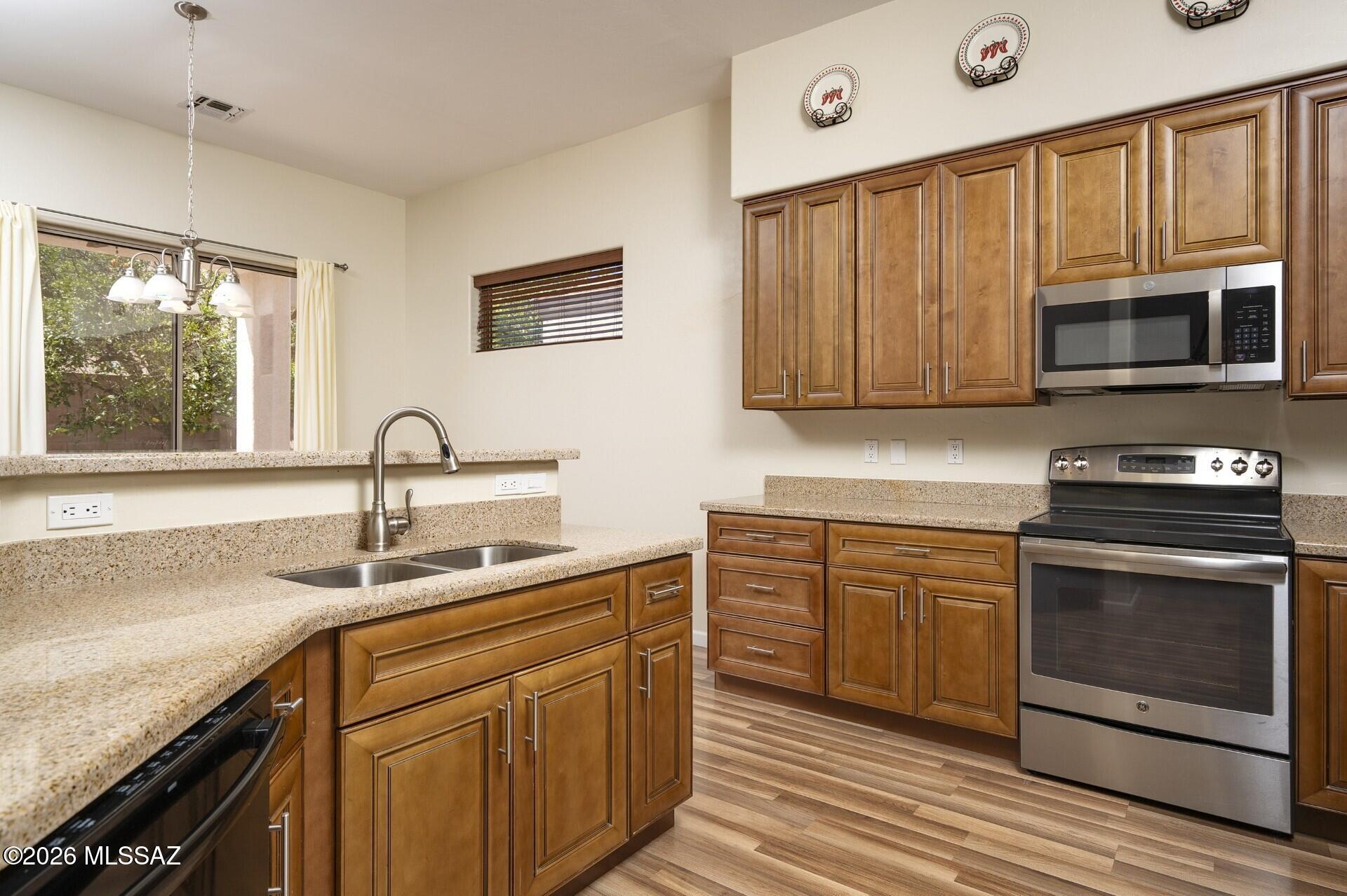 Brand New HVAC just Installed! Updated, Meticulously Maintained 2nd Home that Shows Like New. Gated Community at Sabino Canyon and Tanque Verde.  You'll feel right at home the moment you arrive.  Nicely Landscaped Front Elevation, Gracious Entry, Light-filled Floor Plan, Clean Lines, High Ceilings and No Interior Steps.  This Popular ''1882'' AF Sterling Model includes an Extended Garage.  Gorgeous, Custom Kitchen and Bathrooms, Fine Quality and Craftsmanship.  Handsome Wood Flooring and Granite Surfaces.  Charming Patio and Yard with Lovely Citrus Trees, just the right size to enjoy.  This is a Great Value, so don't let this one get away!  Wonderful HOA features 3 Community Pools & Spas, Front Yard Landscaping, Sidewalks and More.