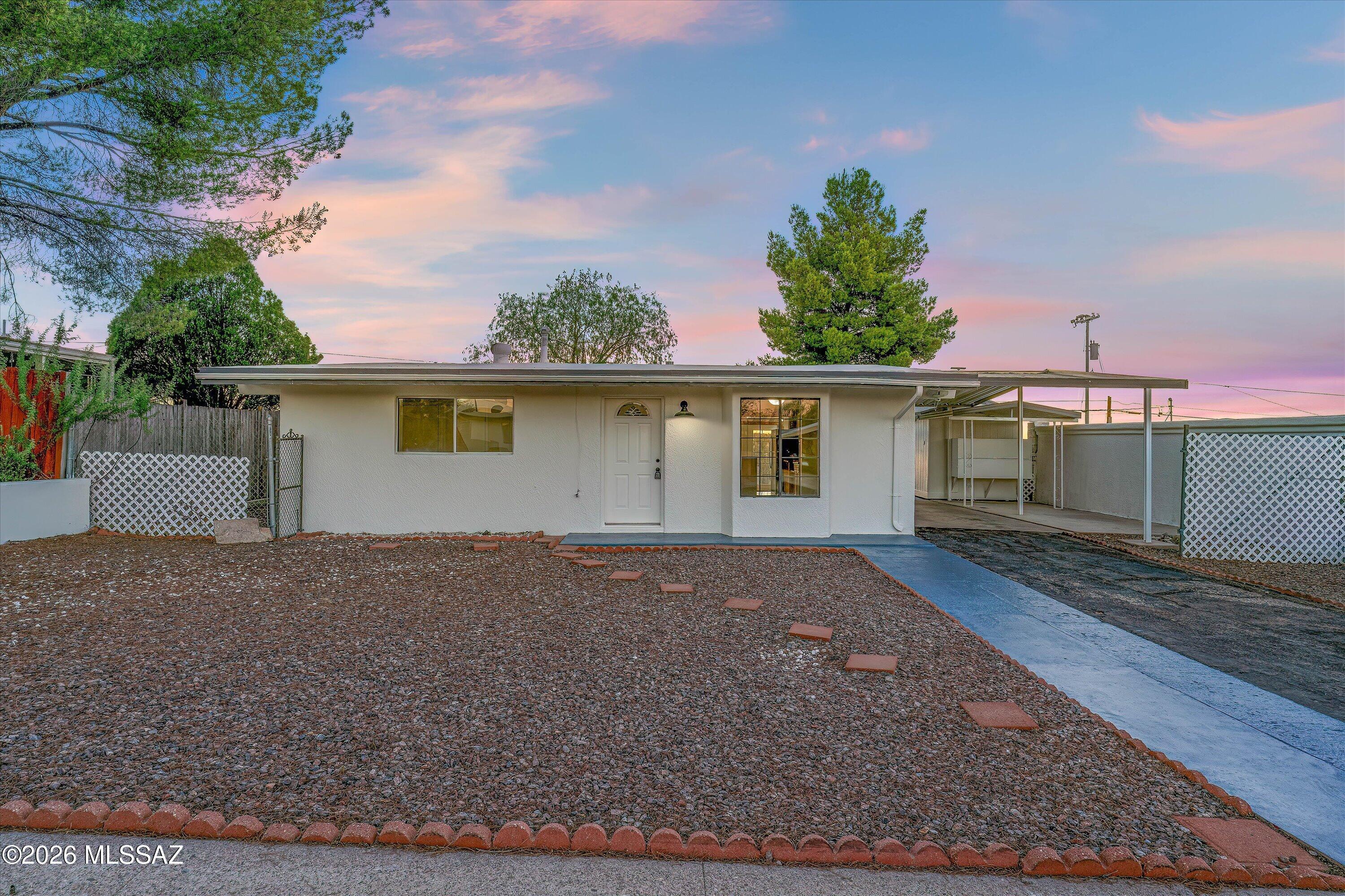 This clean and move-in ready 2-bed 1-bath home is full of charm! Enjoy privacy and unobstructed views from the fenced-in backyard that borders desert (no neighbor behind!). Both interior and exterior have been freshly painted, and the expanded kitchen features brand new stainless steel appliances (dishwasher & gas range) and updated cabinetry. The enclosed laundry room includes washer and dryer, along with a tankless water heater. Dual pane windows throughout, for maximum efficiency! Both bedrooms features brand new carpet and ceiling fans, while the bathroom has been remodeled with a new tub/shower surround, tile flooring, and sink/vanity. The large covered porch is the perfect place to watch sunsets, and the backyard features a variety of sheds / outbuildings for additional storage. Schedule a tour today, and come find the home you have been looking for!