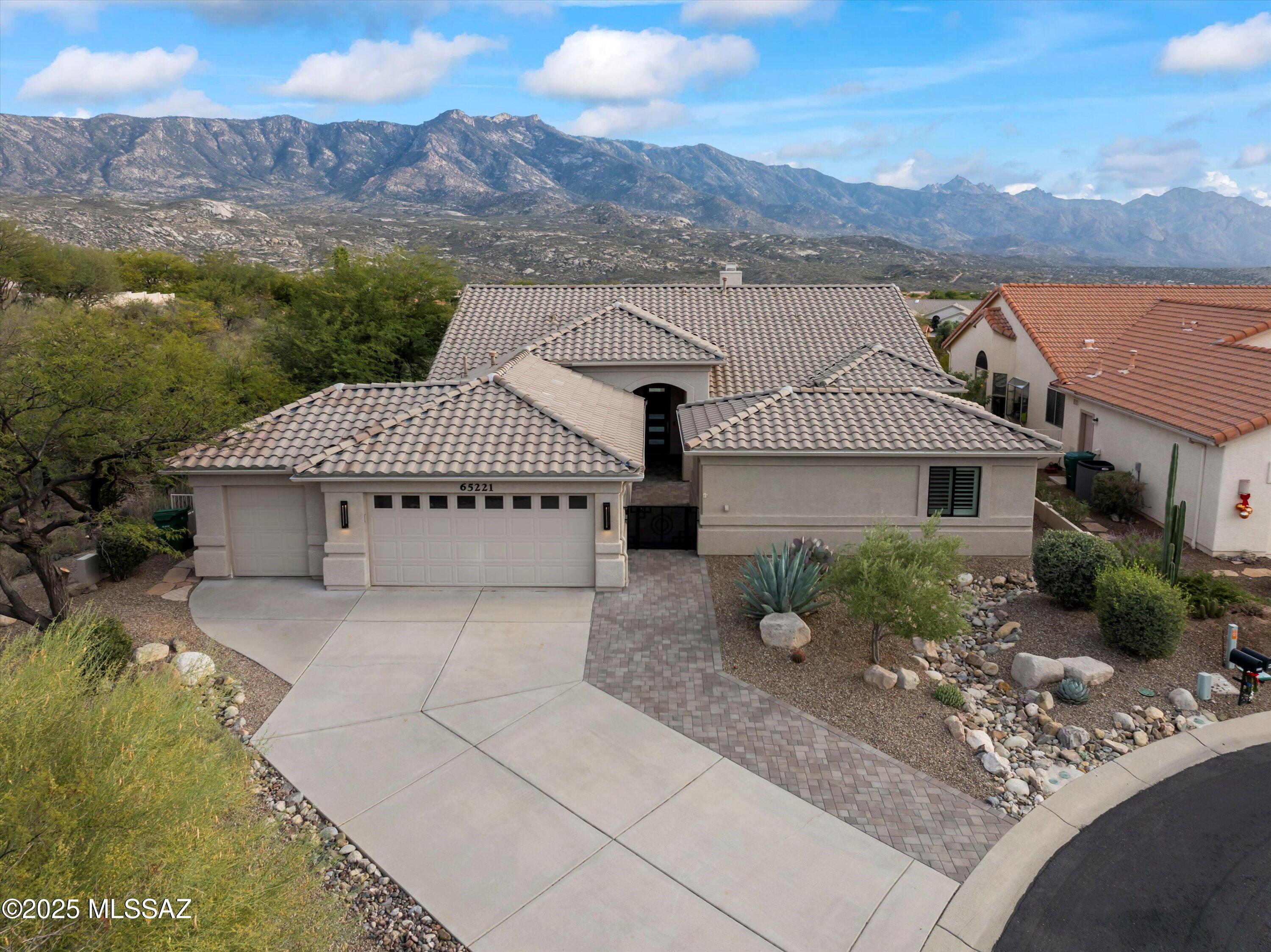 This stunning residence showcases a one-of-a-kind renovation that highlights the best of SaddleBrooke. Located at the cul-de-sac's end, it offers breathtaking, unobstructed mountain views and an open layout with three bedrooms, including a secluded guest Casita plus a conveniently located Den featuring a wall of built-in desks and storage. A private courtyard invites you into this unique home, which is thoughtfully designed to showcase stunning mountain views. The great room features a wall of windows that frame the view and is open to both the dining area and the gourmet kitchen. In the kitchen, you'll find custom cabinets, granite countertops, double convection ovens, a gas cooktop, and high-end stainless appliances, including three Zephyr beverage refrigerators. The primary suite showcases impressive mountain views, a stylish en-suite bathroom with a walk-in designer tile shower, and a dream walk-in closet. The main house also includes a comfortable guest room. Outdoor areas are thoughtfully designed for entertaining and to optimize appreciation of the surrounding vistas. Guests may gather around the gas firepit or unwind on the extended paver patio while taking in the remarkable views. This is an ideal home for enjoying SaddleBrooke's wonderful lifestyle.