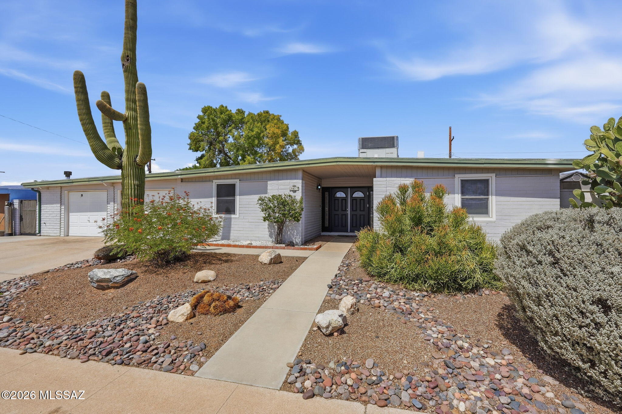 So much space and flexibility in this 4 bedroom, 2 bath East Tucson home with 2,343 square feet! With a great room, separate living room AND a bonus room, there is plenty of room for everyone. Use the bonus space as a den, home gym, bar, game room or whatever fits your lifestyle. The kitchen features ample soft-close cabinets, a breakfast bar, plenty of storage and two refrigerators. The split bedroom floor-plan offers added privacy, and double entry doors give the home a welcoming entrance. Central A/C plus a mini split help keep things comfortable year-round. Outside you'll find mature trees, low-maintenance artificial turf and a screened and enclosed patio that gives you even more usable space. Conveniently located in East Tucson close to shopping, schools, parks and bus lines.