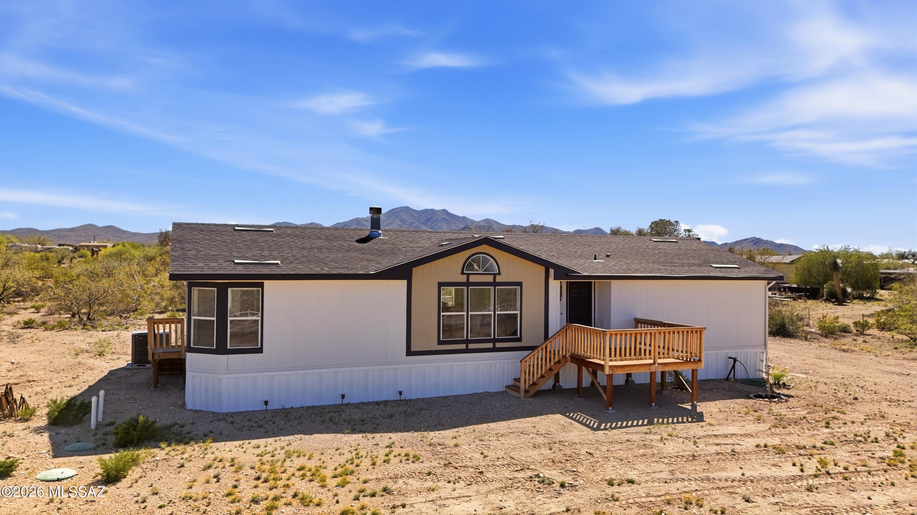 Commanding the corner of a full acre, this property delivers sweeping 360° mountain views and zero HOA restrictions. Inside, a smart split floor plan centers around a massive primary suite with spa-style bath, soaking tub, walk-in shower, and oversized closet. The kitchen features a breakfast island, abundant cabinetry, and skylights that flood the space with natural light, carried through expansive windows in the living areas. Granite surfaces throughout, bay windows in every bedroom, and a wood-burning fireplace with heat-disbursing fan add both style and function. Topped off with a brand-new roof--this one stands above the rest.