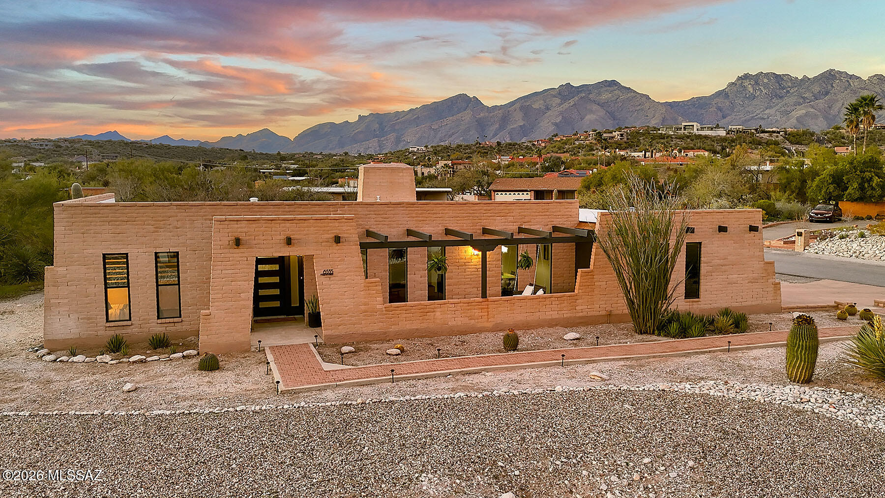 Beautifully designed home on a hill with both city & mountain views!  Two spacious living areas - each with it's own fireplace - dining room & eat-in kitchen provide plenty of space for hosting & everyday living!  Exterior accordian 12' doors open up onto a large 500 sq ft porch for indoor/outdoor living.  Kitchen features white oak cabinets with pull out shelving, pantry cabinet, microwave cabinet & pull-out trash AND new appliances.  Plenty of storage in the laundry/mudroom-TWO master closets-exterior storage room, garage & shed!  Low maintenance desert landscaping in both front & back.  Extra space behind the back yard wall - over ½ acre lot!  Come see your new home today!