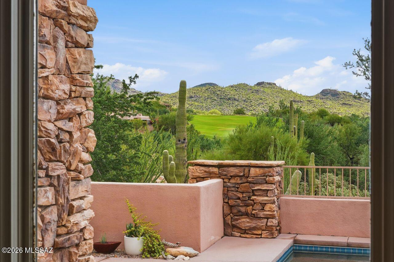 Perched in one of the most coveted locations in The Gallery, this former model Cottage overlooks the 9th fairway of the Gallery Golf Course while capturing breathtaking Catalina & Tortolita Mountain views. Meticulously maintained & thoughtfully updated, this highly desirable floor plan features two luxurious primary suites for outstanding indoor-outdoor living. The inviting great room showcases a frpl w/ raised hearth, wet bar & beautiful beam-and-plank ceilings, creating the perfect setting for entertaining. The chef's kitchen is a dream, offering spacious marble island, SS appl, gas cooktop, built-in oven, microwave, breakfast nook & a stunning frameless corner window that perfectly frames the spectacular views. Each spacious primary suite serves as a private retreat w/frpl, patio access dual closets, jetted soaking tub, and generous walk-in shower. A powder room provides added convenience for guests. 
Step outside to the beautifully landscaped backyard featuring multiple seating areas, a fireplace, and built-in BBQ, all designed to take full advantage of the golf course and mountain vistas. Additional highlights include a laundry room with sink and cabinetry, a 2-car garage, newer mechanical systems, paid-for rooftop solar, and a Tesla charging station. 

HOA covers front landscaping, pest control, trash, street and gate maintenance.

Experience luxury desert living at its finest and discover all that The Gallery Golf Club has to offer. Call for your private showing.