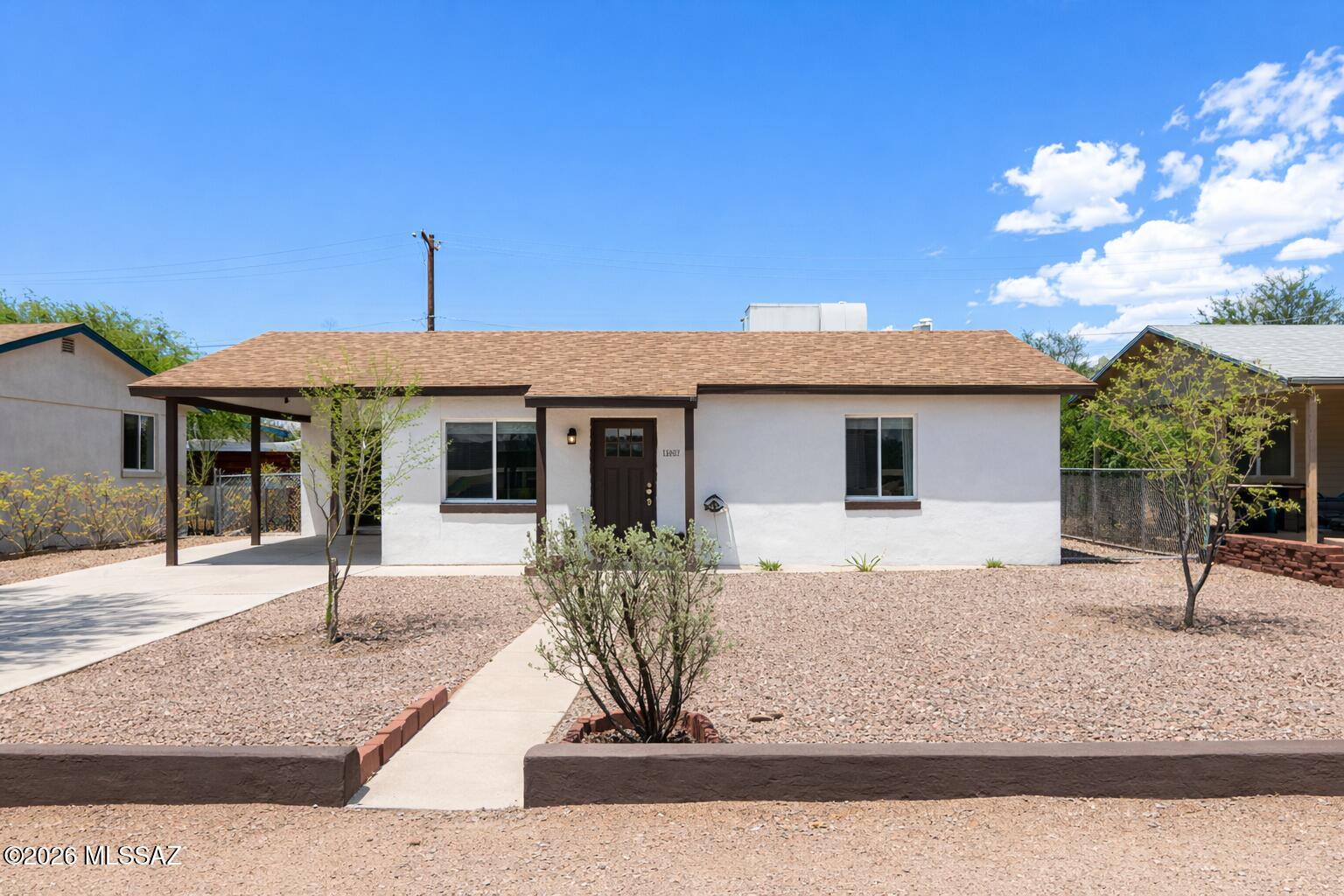 Beautifully remodeled home in a prime central Tucson location near the University of Arizona and top hospitals, nestled in a quiet neighborhood. Featuring a modern open-concept layout with a bright living space, new wood-look tile flooring, recessed lighting, and abundant natural light. The stunning kitchen offers custom dark green cabinetry, quartz countertops, subway tile backsplash, a center island, and sleek black appliances. Enjoy an expansive backyard with low-maintenance desert landscaping, offering a blank canvas to create your ideal outdoor space, whether it's a garden, turf, or custom design. A detached storage shed provides extra space, while the fully fenced yard adds privacy and security. Ideal for first-time buyers or investors!