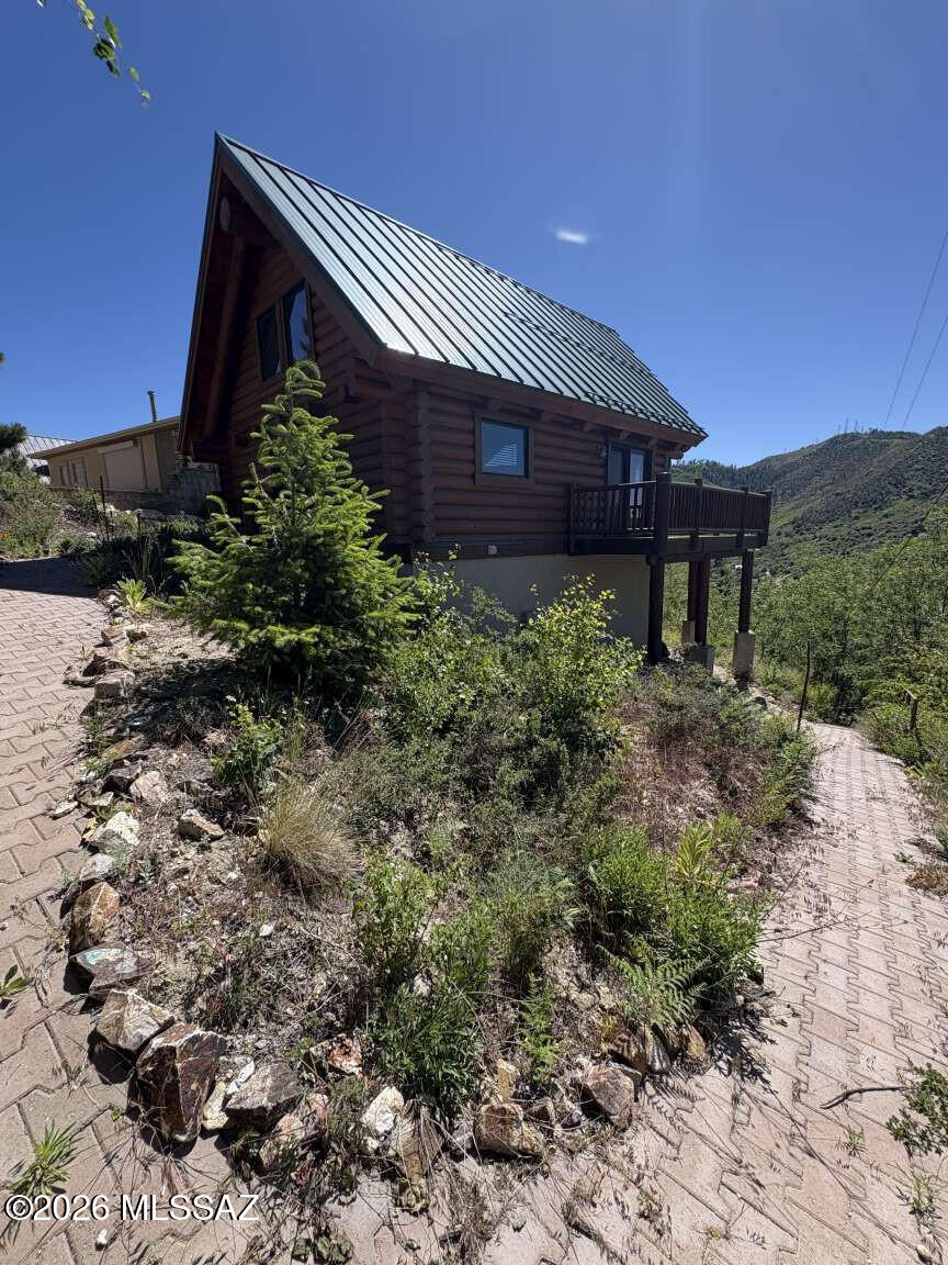 Well maintained gorgeous log cabin built in 2006 with metal roof. Beautiful mountain views with wrap around deck. One bedroom loft and one bath. Spacious living room area with wood burning fireplace. Large eat in kitchen with counter top seating. Ample space for a large dinning table. Tile floor. Large finished basement with pellet stove heating and washer and dryer hookups. Plumbing for an additional bathroom in the basement exists. There are lots of possibilities for the recently finished basement. Brick pavers provide parking for two vehicles. Year around accessibility with paved streets to the cabin.