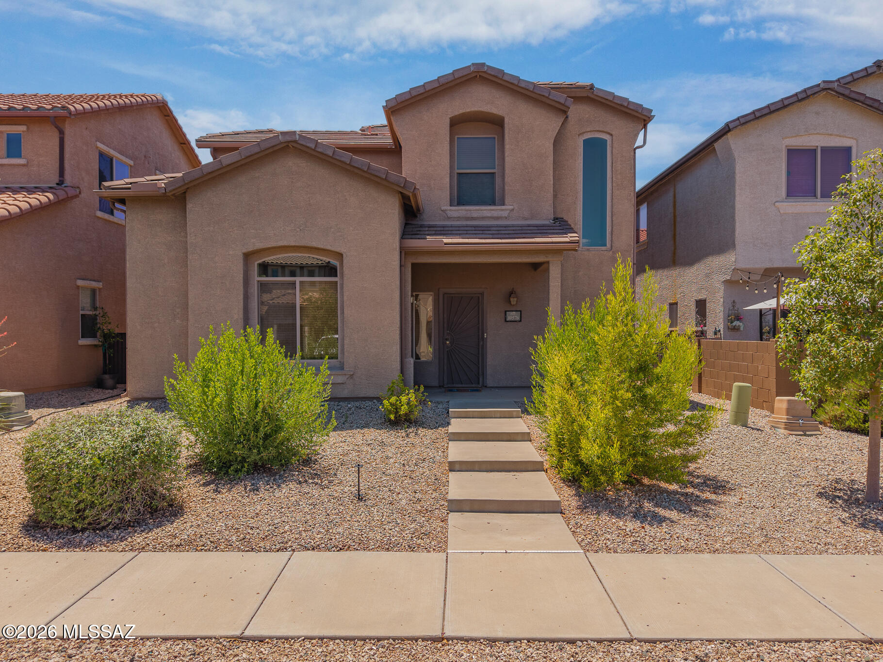 Discover this inviting 3 bedroom, 2.5 bathroom home in desirable Southeast Tucson, where comfort, convenience, and community come together. Featuring soaring ceilings, abundant natural light, and stylish wood look tile flooring, the open concept layout offers a bright and welcoming atmosphere perfect for everyday living and entertaining. The spacious kitchen flows seamlessly into the dining and living areas, while upstairs you'll find generously sized bedrooms, including a private primary suite. Outside, enjoy low maintenance desert landscaping and a private patio ideal for relaxing under Arizona skies. Located in a well maintained community with a sparkling pool and sand volleyball court, this home is just minutes from top rated Vail area schools, shopping, dining, parks, Davis Monthan Air Force Base, Raytheon, and easy access to I10. Move in ready and perfectly positioned to enjoy the best of Southeast Tucson living.