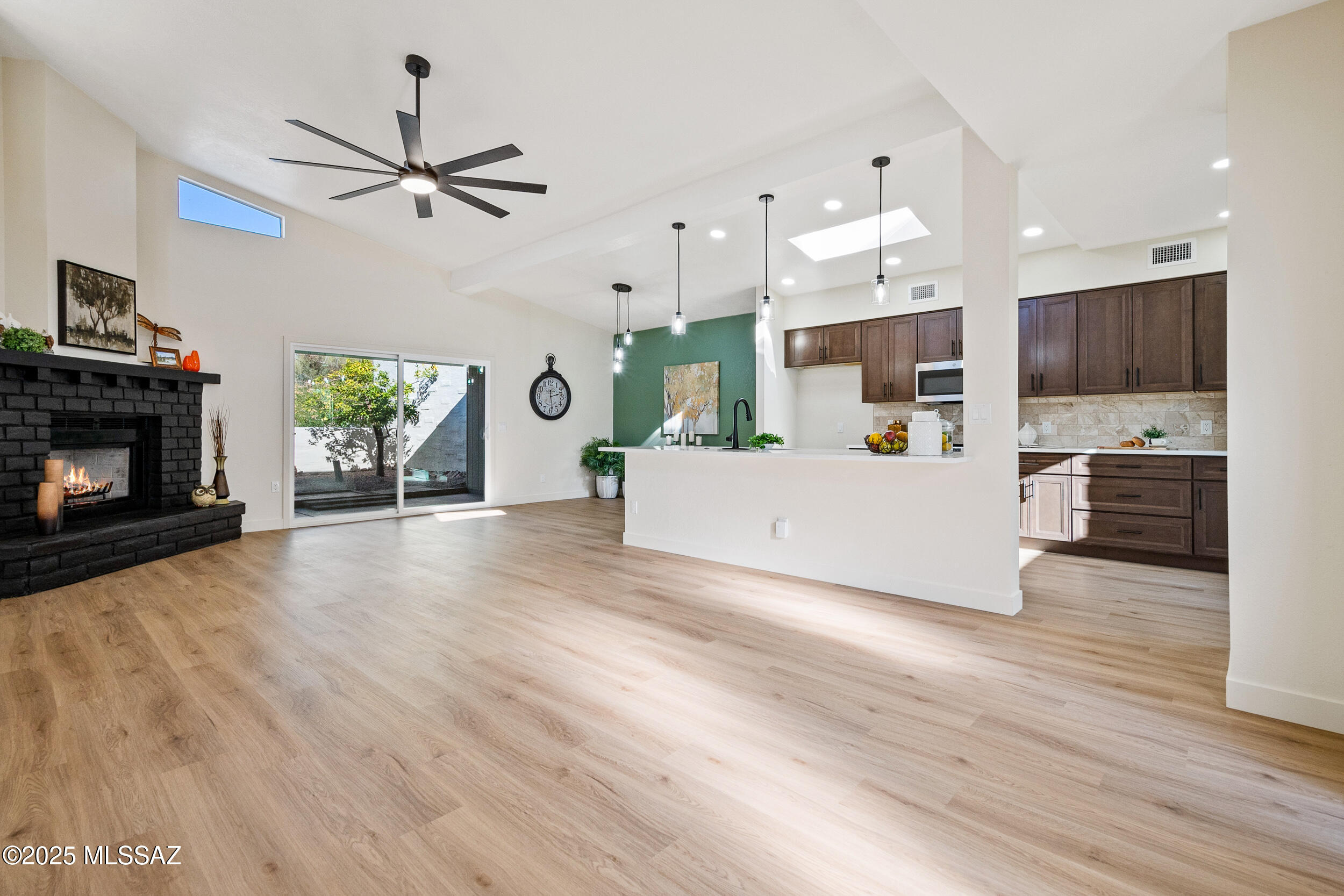 Sellers are licensed real estate agents in Arizona. Beautifully updated home featuring luxury wood plank flooring throughout and an open, light-filled great room floor plan. The spacious kitchen, living, and dining areas offer vaulted ceilings, slab quartz countertops, gorgeous cabinetry, a large center island with pendant lighting, stainless steel appliances, wine/beverage cooler, and two pantries. Design details include black-accented lighting, ceiling fans, plumbing fixtures, mirrors, hardware, and a coordinating wood-burning fireplace. Home offers two large bedrooms, custom tile showers, ample closet space, and a recently serviced HVAC system in excellent condition. NEW ROOF with 5-year warranty. Enjoy mountain views and added privacy from the covered patio that lives like an additional outdoor room.
Property includes a large gated front yard, front and rear storage rooms, and a 2-car garage with additional driveway parking. North/South orientation. Community pool/spa heated. Close to shopping/dining and Sabino Canyon recreation area.