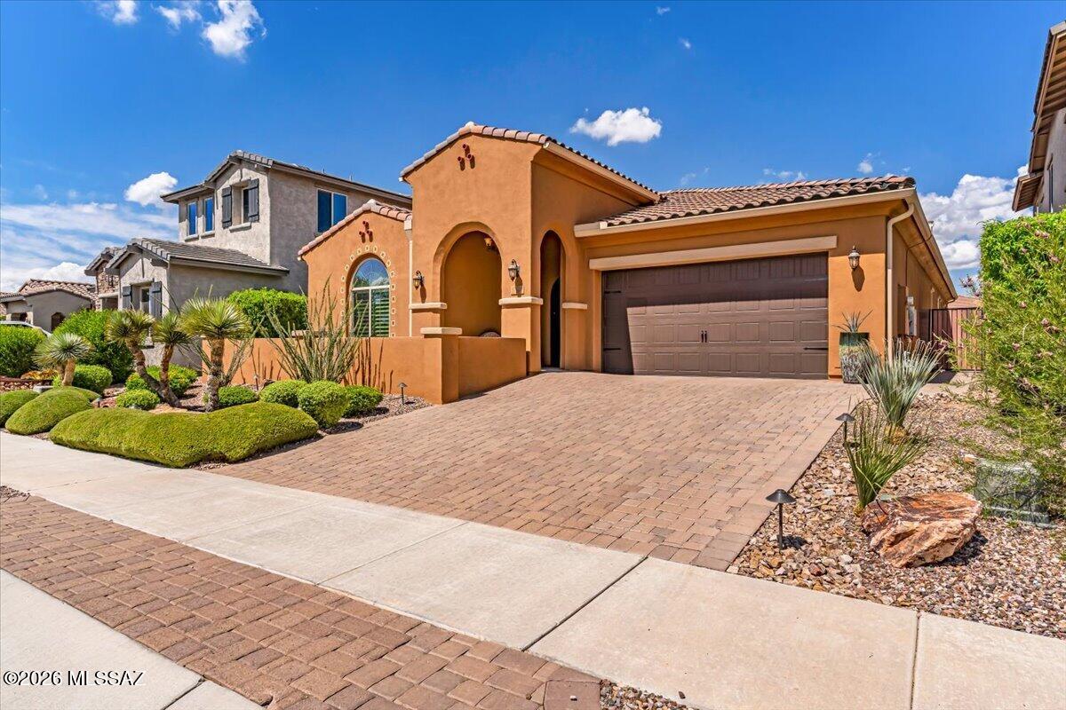 Designed with a discerning eye and maintained with exceptional care, this showroom-quality home celebrates refined desert living. Soaring ceilings, exposed wood beams, porcelain tile and wooden shutters enhance the interior. The chef's kitchen shines with quartz countertops, a waterfall island, gas cooktop, double ovens and abundant cabinetry. Expansive glass doors open to a private backyard oasis with a sparkling pool, turf, pavers, custom hedges, an outdoor cooking area with concrete counters and a fire pit with wraparound seating. Owned solar, whole-home and patio speakers, Kinetico water softener, reverse osmosis, and recent paint inside and out add comfort. Tandem 3-car garage with epoxy floors, EV charger and ceiling storage. Near parks and community centers.