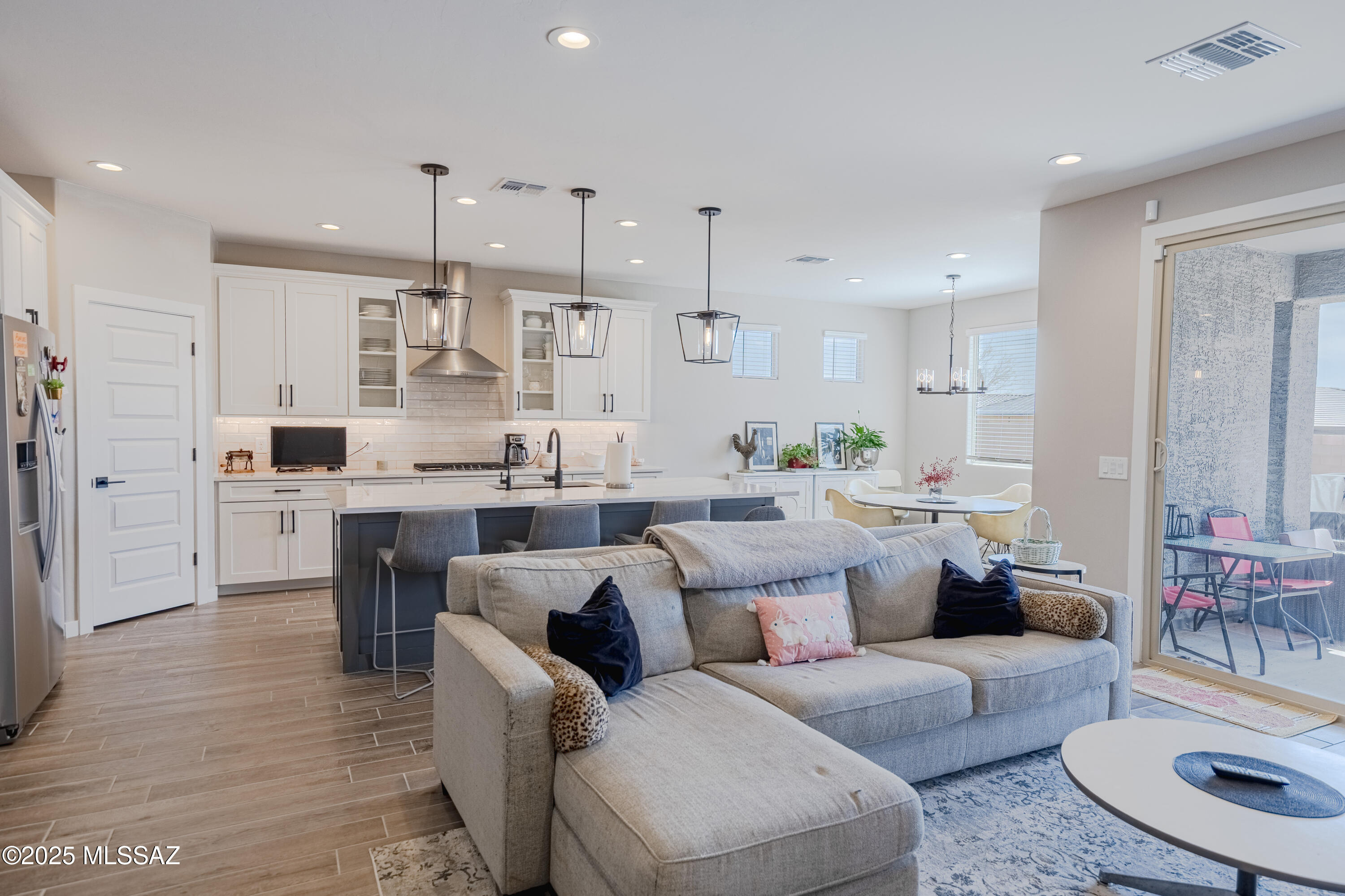 Built in August of 2024, this almost new, contemporary home in the Saguaros Viejos community has over $110,000 in builder upgrades! The open concept interior layout is fantastic for both entertaining and daily living. The home offers 3 spacious bedrooms, a very large den/dining, and 2.5 bathrooms. Premium finishes include stainless steel appliances, designer kitchen, quartz countertops, a HUGE primary shower, additional energy efficient recessed lights, extended length 3-car tandem garage, and so much more! Ideally located between Wilson K-8 & Ironwood Ridge High School, there are multi-use paths, trails, and plenty of shopping & restaurant options nearby. A pool sized backyard too! You'll be hard pressed to find a nicer Oro Valley home at this price!