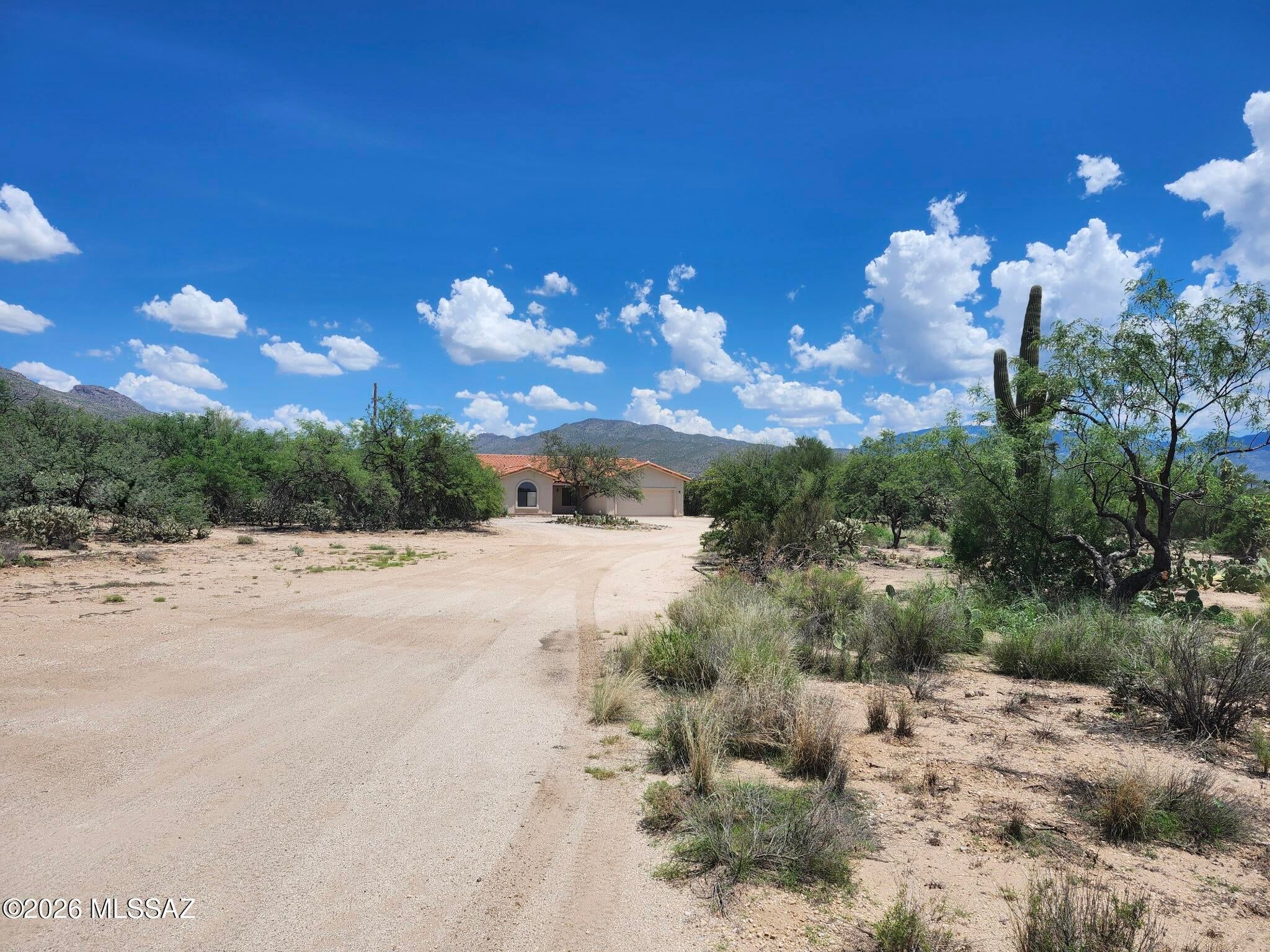 Rare find!  This exceptional 3-bedroom, 2-bath home sits on 2.8 acres, offering plenty of outdoor space. Enjoy breathtaking Catalina Mountain views from the pool and spacious covered patio with an enclosed backyard and desert landscaping. Inside you'll find a well-equipped kitchen and island with all appliances, a formal living room with cozy fireplace and a formal dining room, breakfast nook in the kitchen.  The primary suite has an oversized newly remodeled bathroom with free standing bathtub and a large walk in closet.  The guest bathroom is also newly remodeled.  The home features Saltillo tile throughout, ceiling fans, ample storage space, laundry room with washer and dryer, neutral paint scheme, brand new A/C and hot water heater, along with a split-bedroom  floor plan.