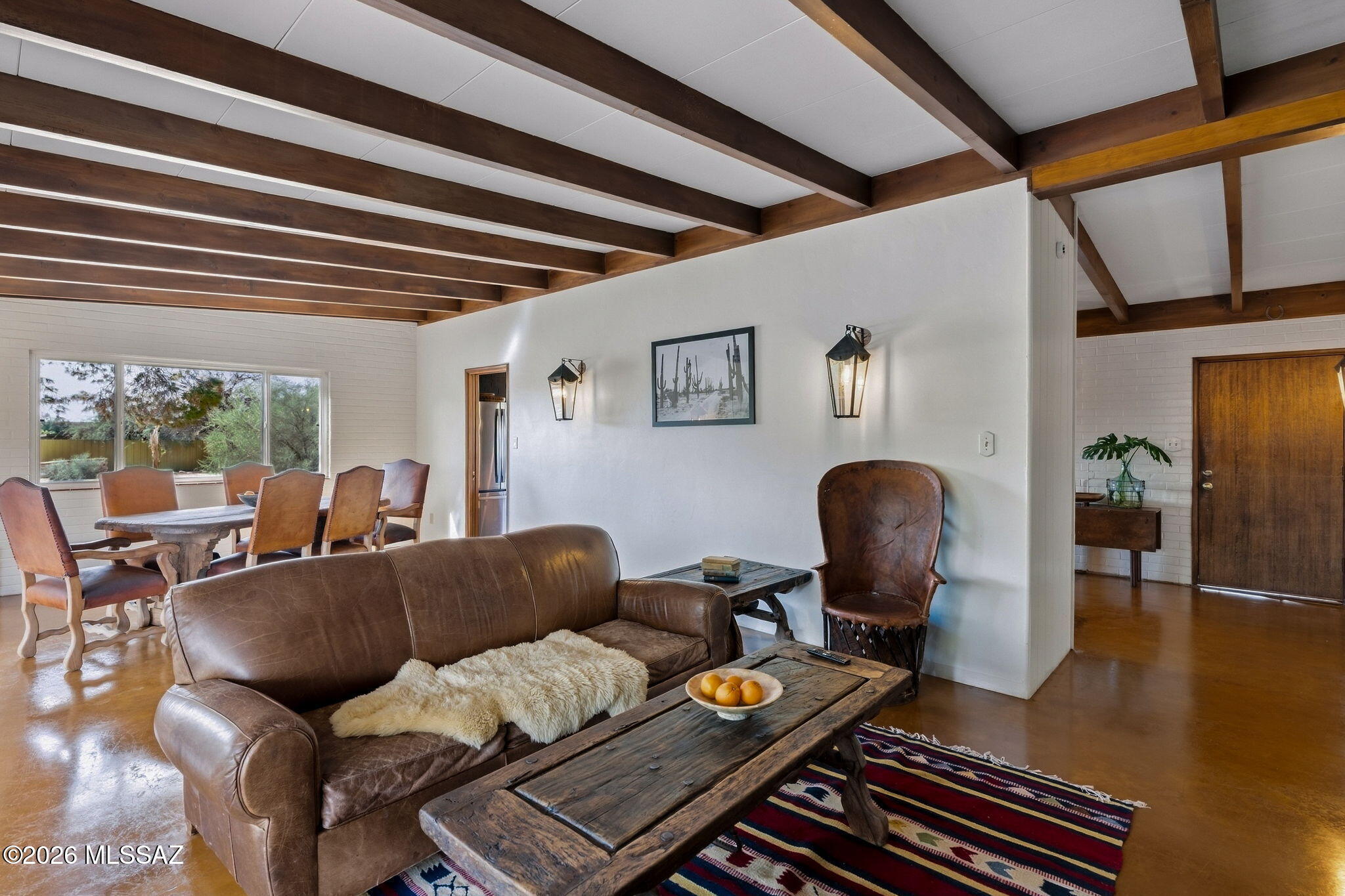 Tucked away on nearly two acres, this property   delivers a rare lifestyle where privacy meets premier convenience. This solid brick residence sits just minutes from Whole Foods and fine dining at Casas Adobes Plaza. Zoned for horses & NO HOA! Thoughtfully curated details, rich finishes, and chic, fully renovated bathrooms establish an elevated ambiance rooted in Tucson charm. Lush landscaping creates a private bird-watching oasis, while the expansive backyard invites endless entertaining. Unwind beside the fire pit as the desert air cools, or take a refreshing dip in the pool framed by magnificent mountain views. Turn-key & worry-free with a host of upgrades including electrical & plumbing infrastructure. Come experience a home that redefines classic Tucson living.