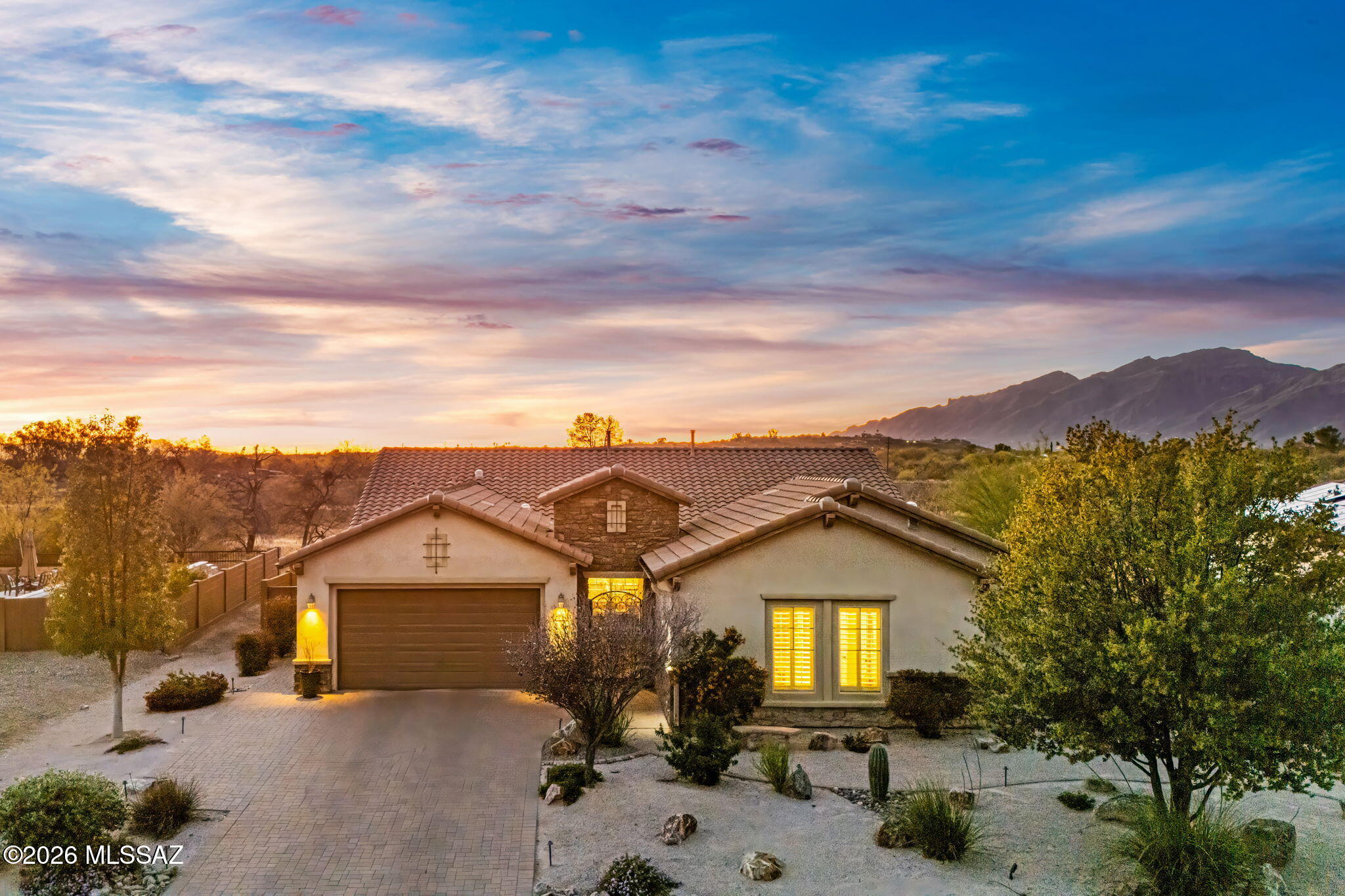 (Sellers will consider offers within a range of $895,000 to $965,000.) Welcome to this stunning 2015 Pulte Homes model home located in the exclusive gated enclave of Desert Willow Ranch. This pristine 4-bedroom, 4-bath residence offers approximately 3,400 sq. ft. of thoughtfully designed living space on an expansive half-acre lot, including a creatively transformed third garage that now serves as a private guest suite complete with its own full bath. Step inside to an impressive great room that flows seamlessly into a beautifully appointed kitchen featuring granite countertops, a large center island, an oversized walk-in pantry, stainless steel appliances, and an upgraded 5-burner Wolf gas cooktop--perfect for both everyday living and entertaining. The well-designed split floor plan provides an ideal balance of open gathering spaces and private retreats. The primary suite is a true sanctuary, showcasing sweeping mountain views through expansive picture windows. The en-suite bath is equally impressive, highlighted by distinctive diagonal tile flooring that adds both texture and elegance. Outdoors, enjoy a professionally designed and paved courtyard, driveway, and back patio that lead to a meticulously landscaped backyard. Here, you'll find a custom planter, a cozy outdoor fireplace, and a sparkling pool with a captivating water feature--creating a private desert oasis. Ideally situated, the property offers breathtaking mountain views and direct access to scenic walking trails along the Agua Caliente Wash, just steps from your backyard. This exceptional home is a perfect blend of luxury, comfort, and Arizona desert beauty--an outstanding opportunity to experience refined desert living at its finest.