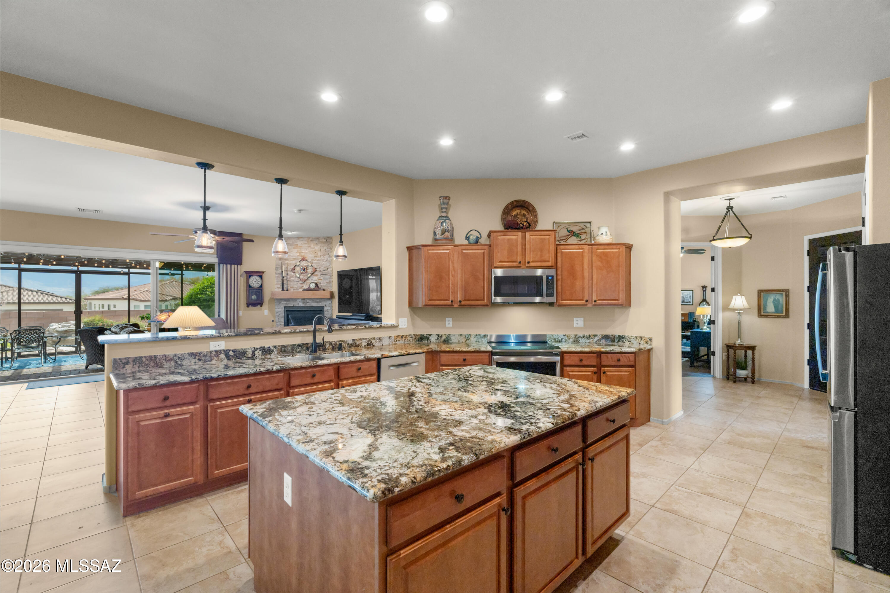 Imagine starting your mornings on a peaceful screened patio, coffee in hand, taking in gorgeous mountain views while listening to the gentle sound of the backyard fountain in this stunning, move-in-ready home featuring valuable paid-for solar. This pristine and beautifully maintained residence offers a refined blend of comfort, style, and thoughtful upgrades throughout. Recently enhanced spaces include a completely renovated half bath featuring a new vanity, as well as a redesigned laundry room with new cabinetry and countertops that provide both function and sophistication. As you enter the great room, the striking fireplace has been tastefully updated, creating a warm and inviting focal point that enhances the elegance of the space. Large sliding glass doors invite natural light into the home and open to a charming screened-in patio--an ideal setting to enjoy morning coffee as the sun rises or relax with dinner in the evening while listening to the tranquil sound of the backyard fountain.

The outdoor space is equally impressive, with mature landscaping supported by an automated drip irrigation system that maintains the beautiful shrubs, plants, and trees throughout the property.

Inside, the home is designed with comfort and flexibility in mind, featuring two well-appointed primary suites. The main primary suite includes a spacious walk-in shower and an expansive walk-in closet, offering a true retreat within the home.

In the kitchen, you have a brand new induction cook top for those who love to cook or love to cook to entertain.

Additional features include a garage outfitted with exceptional built-in cabinetry for abundant storage, a convenient electric vehicle charging station, and a whole-home water softener system.

Every detail reflects care and quality, making this truly a top-notch home--ready for its next owner to move in and enjoy.