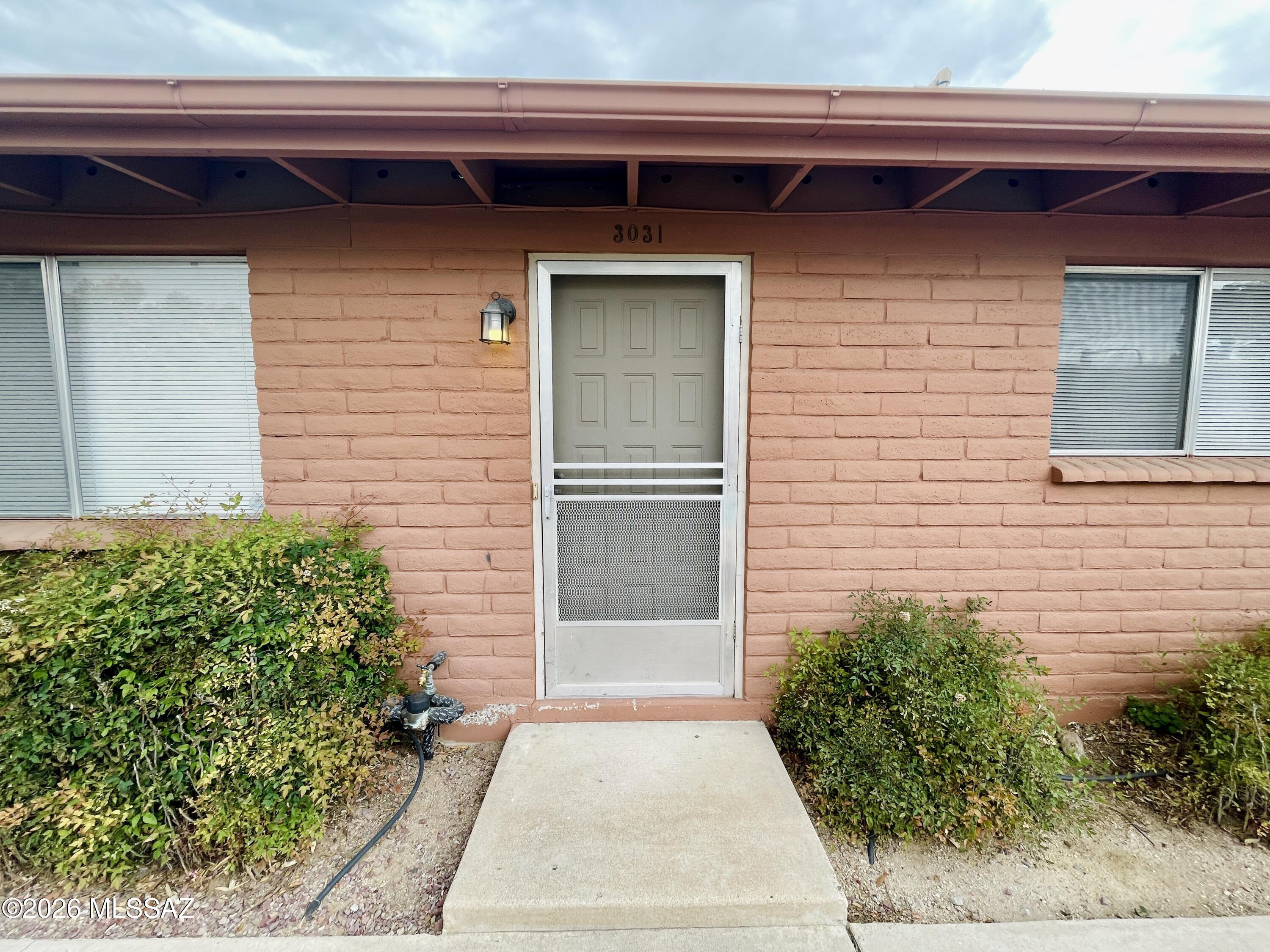 Come view this centrally located, single story home in a gated community with a community pool! Two bedrooms, one bathroom, tile floor throughout with air conditioning, storage locker, and a covered parking space make living comfortably simple and easy.