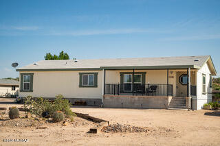 Country Cousin Cutie Welcomes You Home!  Roomy three-bedroom, two-bath home on One Plus acre, offers newer vinyl wood plank look flooring, fresh paint, all kitchen appliances & Washer & Dryer too.  Covered front deck and huge covered back deck, perfect for enjoying Gorgeus sunrises, sunsets & fabulous mountain views.  With a spacious two car garage, a Second one car garage, PLUS a double RV Carport, you have covered parking for FIVE vehicles, so bring all your toys! Two car garage, second garage, plus double carport, on one+ acre, with horses allowed!  Use second garage for work shop, tack room or animal stall.  Features recently refreshed roof, circular driveway.