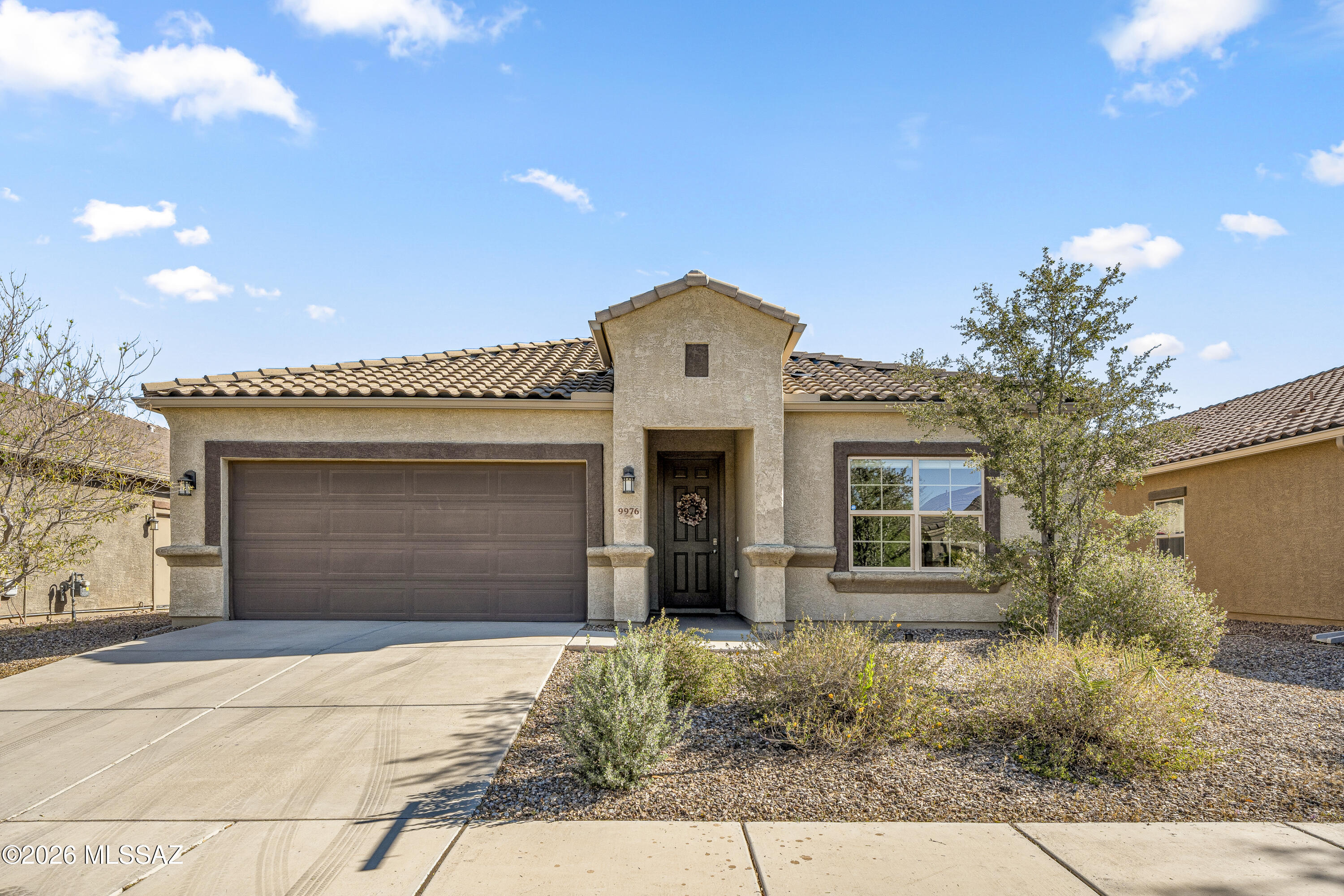 Welcome to this bright and airy 4-bedroom, 2-bath home located in the highly desirable Saguaro Bloom community in Marana. Designed with comfort and modern living in mind, this home features a spacious open floor plan that seamlessly connects the kitchen, dining, and living areas--perfect for both everyday living and entertaining.
The well-appointed kitchen opens to the main living space, creating a bright and inviting atmosphere where family and friends can gather with ease. The generous primary suite offers a relaxing retreat, while three additional bedrooms provide flexibility for guests, a home office, or hobbies. Step outside to a thoughtfully designed backyard oasis. The expansive turf area offers low-maintenance greenery year-round, complemented by raised planting beds perfect for gardening enthusiasts. Custom landscape lighting adds warmth and ambiance, creating the ideal setting for evening relaxation or outdoor entertaining.
Living in Saguaro Bloom means enjoying a vibrant and welcoming community known for its scenic desert surroundings and outstanding amenities. Residents have access to a resort-style community center, two sparkling pools, splash pad, fitness center, and parks. The community also features walking paths, playgrounds, and regular neighborhood events that bring neighbors together.
Conveniently located with easy access to shopping, dining, and I-10, this home offers the perfect balance of peaceful desert living and everyday convenience. Don't miss your opportunity to own a beautiful home in one of Marana's most sought-after communities.
To help make homeownership even more attainable, the sellers are offering a rate buy-down incentive for qualified buyers. This opportunity can significantly reduce your monthly mortgage payment--especially during the early years of the loan--making this home an even better value. By lowering the interest rate through a buy-down, buyers can enjoy substantial savings and improved affordability compared to standard financing. It's a fantastic advantage in today's market and a valuable opportunity to secure a lower payment while purchasing this beautiful home.

Saguaro Bloom is located within top-rated district schools, and Arizona's robust school choice options further enhance its appeal--making it an exceptional community for families seeking quality education at every stage.