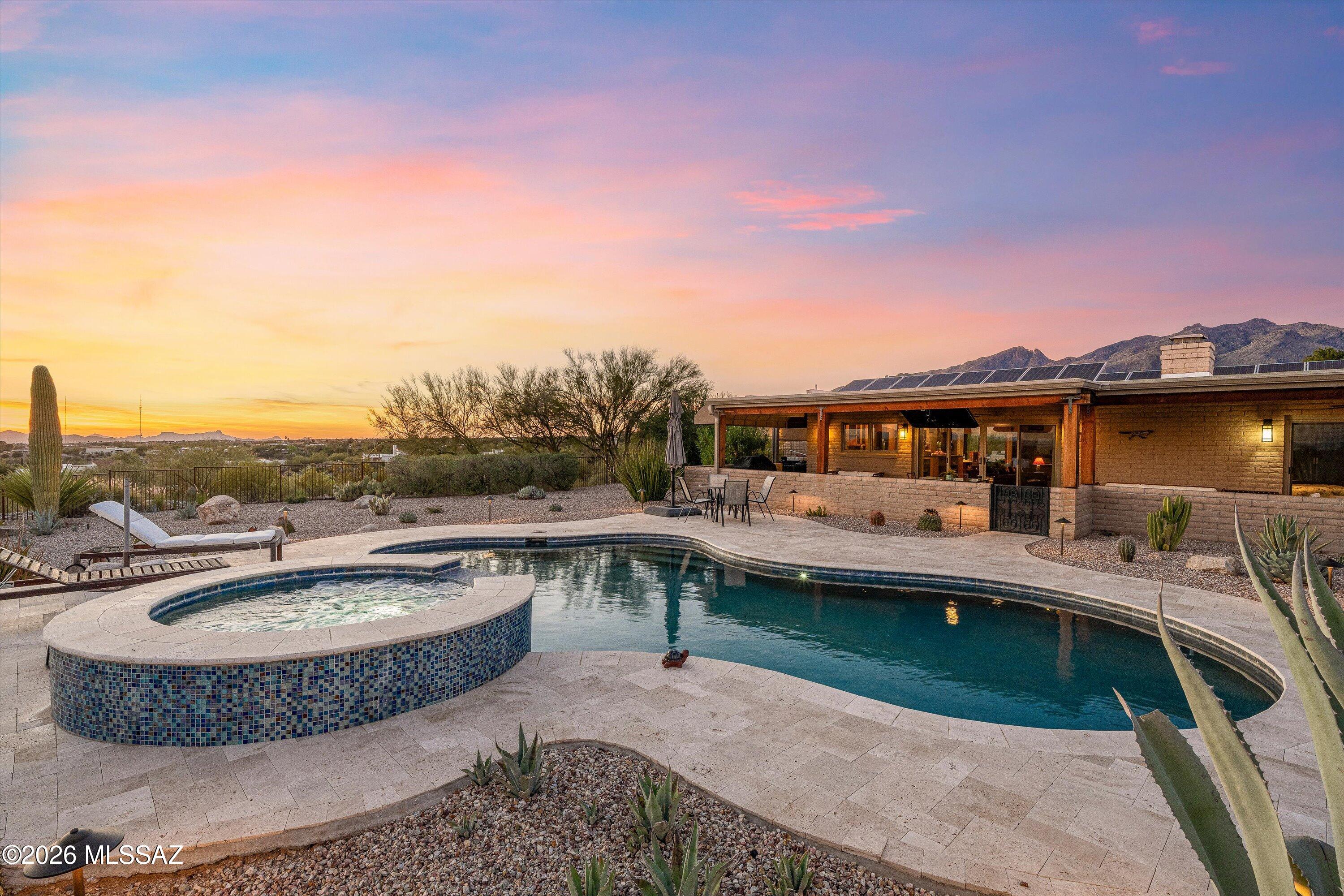 Would you like that feeling of being on top of the world? Located in the heart of the Catalina Foothills, this ridgetop home offers amazing 360-degrees views of the entire Tucson Valley. Sweeping views across the valley offer you front row seats to breathtaking twinkling city lights, majestic mountains, and beautiful sunset vistas. Enjoy the Tucson lifestyle from the rear patio/yard with the sparkling pool, spa & panoramic views - outdoor area perfect for entertaining. Pool and spa newly installed in 2020. Gutted down to the studs for a full renovation in 2009. Care and consideration were given to the contemporary floor plan and appointments, as well as environmentally friendly materials during the reconstruction.