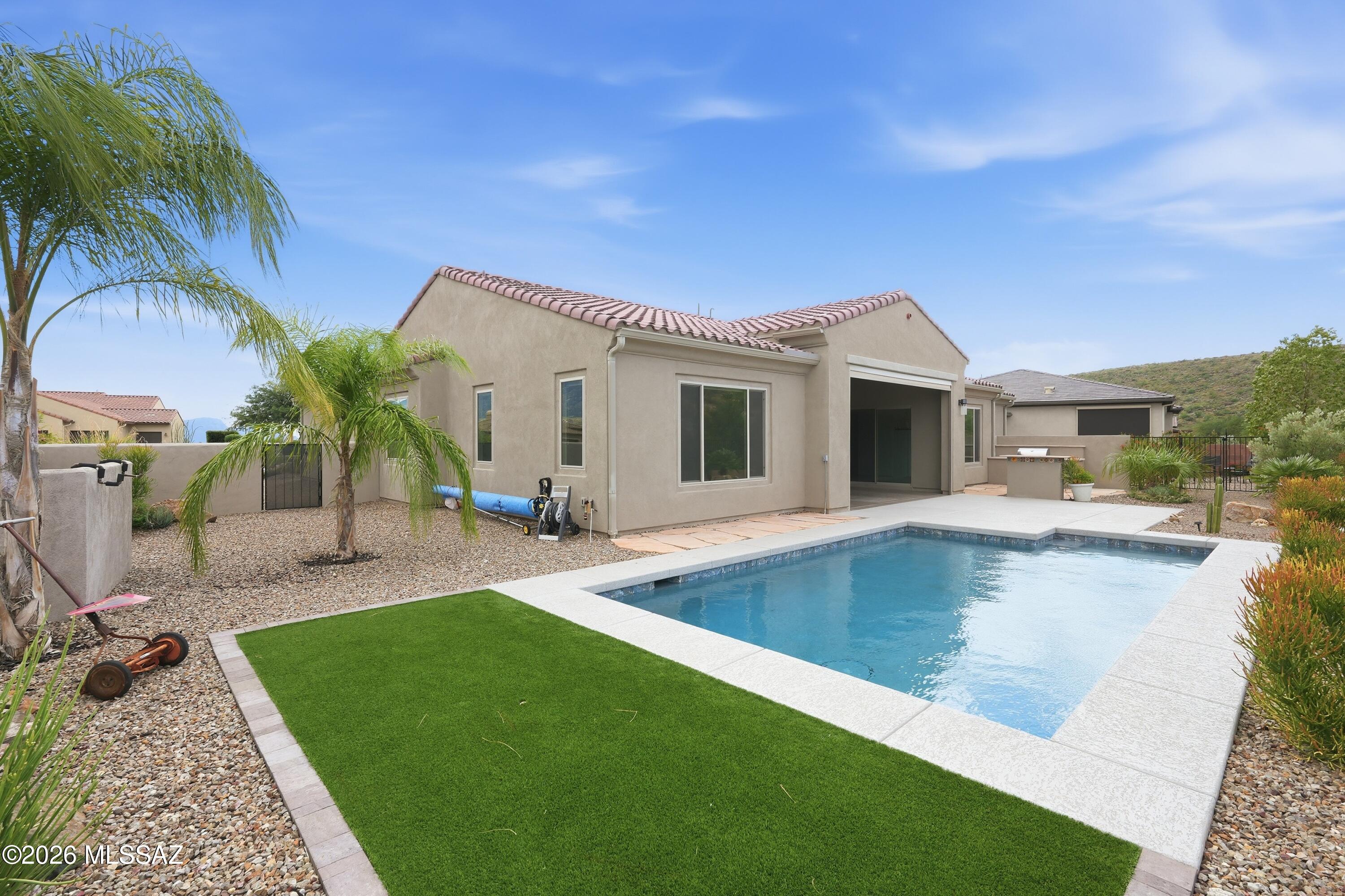 Experience refined desert living in this contemporary 2022 home in The Preserve at SaddleBrooke. Set on a private 0.29-acre lot with Catalina Mtn views, expanded Acacia floor plan offers 2 bedrooms, 2.5 baths, a den and bonus room for a studio, fitness or creative pursuits. The chef's kitchen showcases Wolf & Sub-Zero appliances, quartz counters, designer backsplash and generous pantry. Walls of glass and French sliders open to covered patio with retractable screen. Your private backyard sanctuary features a sparkling saltwater pool, built-in grill, high-top seating and artfully designed landscaping. The serene primary suite captures pool and desert views, complemented by a spa-inspired bath and spacious walk-in closet. Move-in-ready retreat where luxury and the Arizona lifestyle meet.