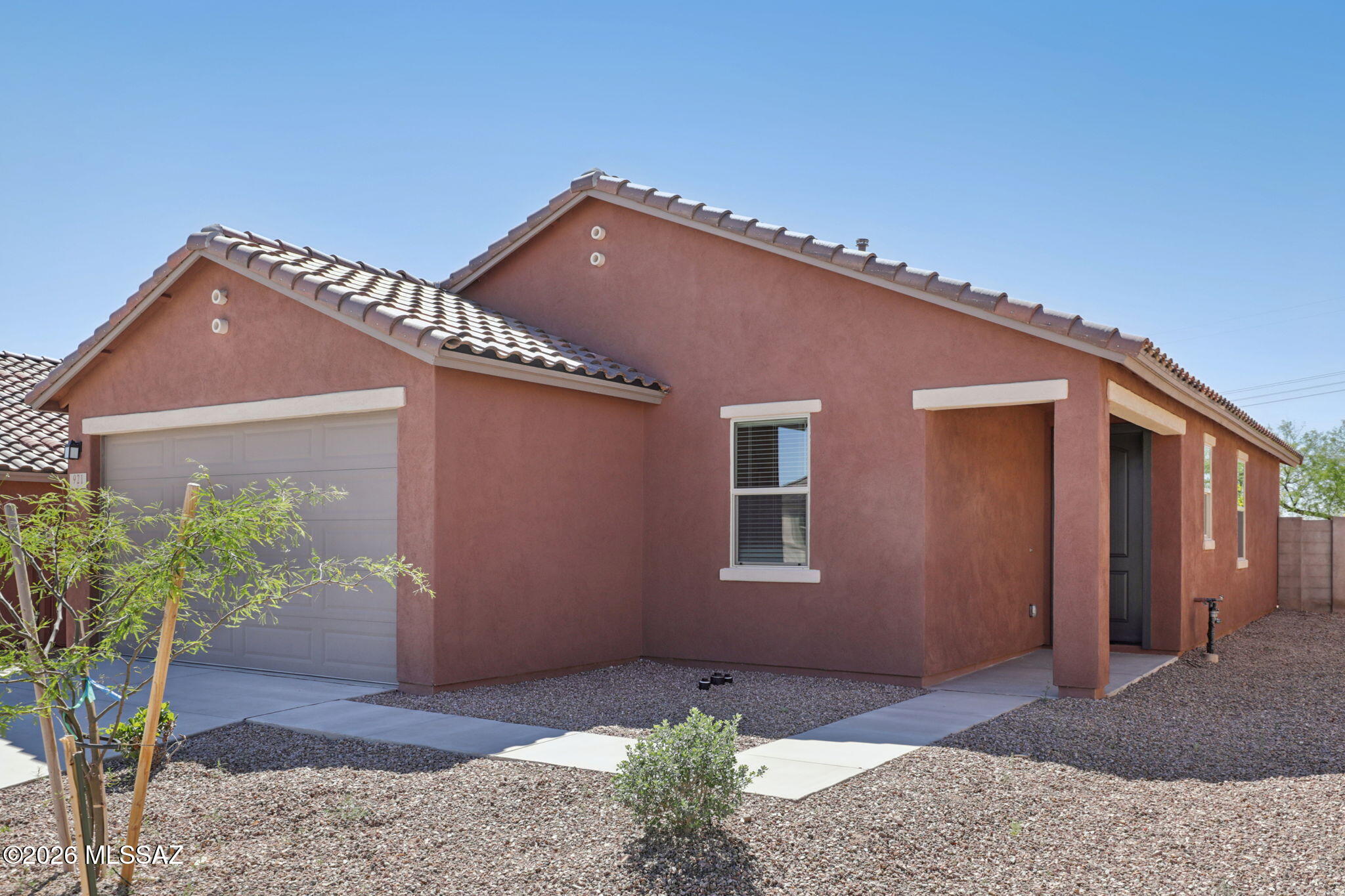 This home is open for self-guided tours daily 8 am - 8 pm. This single-story home features 9-ft. ceilings  and wood-look ceramic tile flooring throughout. The well-appointed kitchen showcases an island, granite countertops, Whirlpool® stainless steel appliances and 42-in. upper cabinets. The primary bedroom boasts a generous walk-in closet and connecting bath that offers a dual-sink vanity. Relax or entertain on the covered back patio. Ask about our special interest rate promotion. Price includes discount predicated on using seller's preferred lender KBHS.