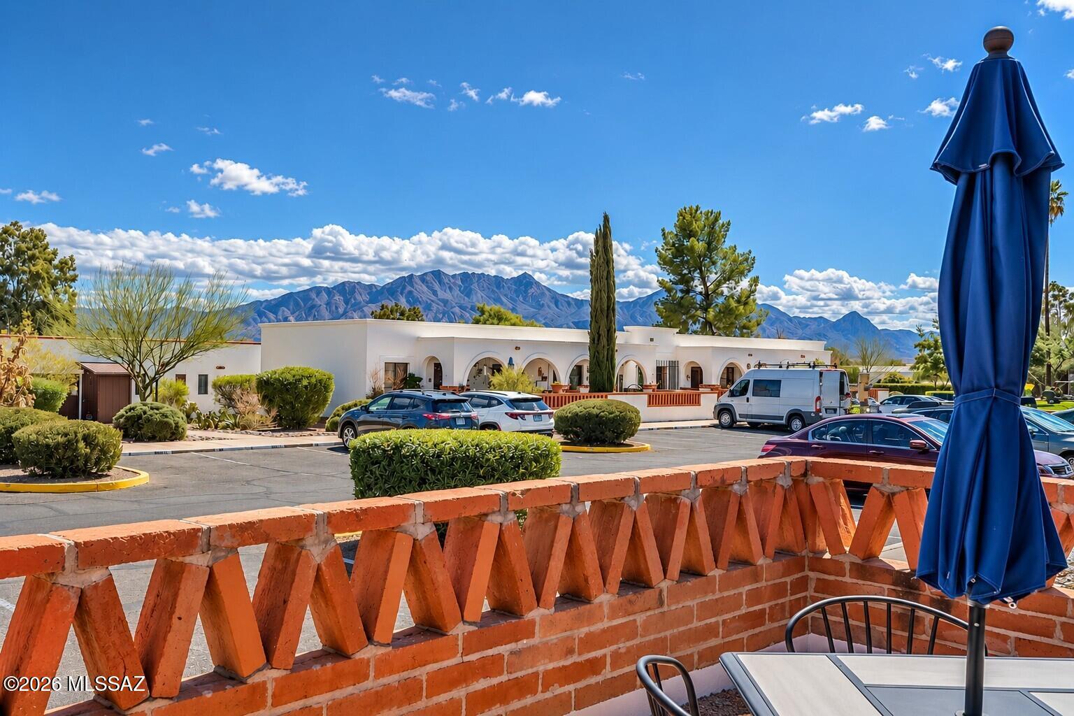 Beautiful mountain views from this east-facing, furnished and clean end unit. Perfectly located next door to the laundry room, half block from the heated pool, and reserved parking is directly in front with a level path to the front door.  Tile floors throughout, dishwasher and full-sized appliances, new bathroom vanity, low flush toilet, ceiling fans in both bedrooms, top-down/bottom-up pleated blinds in living room and bedroom, 3 closets and a pantry, and a no maintenance, freshly painted patio with dining set and umbrella. Electrical panel updated in 2026, interior painted 2023, outside painted 2026, patio wall rebuilt 2025, roof replaced 2023, HVAC replaced 2020. HOA covers roof repair, HVAC, water heater, water/sewer, trash, recycling, pest control, landscaping, pool and road maint.