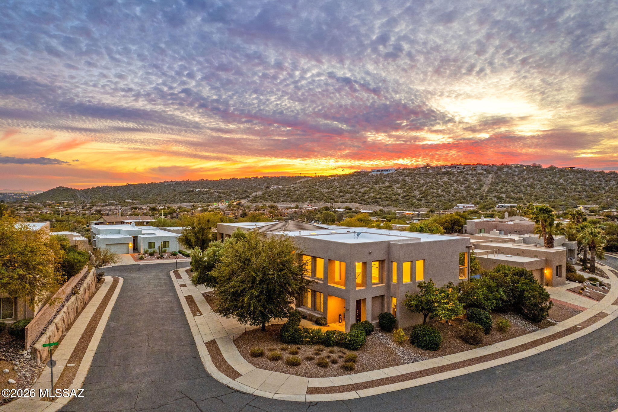 Welcome to your Dream Home in the prestigious Bonita Ridge, a gated community nestled within the serene Catalina Foothills. This architectural masterpiece welcomes you with soaring 20+ foot ceilings and massive clerestory windows that flood the space with sublime natural light, while ensuring privacy. The elegant living room and formal dining area boast custom light fixtures, creating an ambience of sophistication. The chef's kitchen features sleek granite countertops, a new backsplash, stainless steel appliances, and a custom hood.  An inviting breakfast nook, eat-at counter, and an adjacent family room provide ample space for entertaining. A generous guest bedroom and full bathroom on the main floor enhance the home's flexibility. Ascend the grand staircase to the primary suite...MORE where French doors reveal a spacious retreat with a sitting area and a private balcony offering breathtaking mountain views. The newly remodeled ensuite is a sanctuary, with a separate soaking tub, marble shower, custom walk-in closet, dedicated shoe closet, and dual vanities. Upstairs, you'll also find a laundry room, two sizable guest rooms with a Jack and Jill bath, and an additional balcony with stunning city views.
Outside, the backyard is an oasis, featuring a water fountain, mature citrus plants, and lush landscaping, making it an ideal retreat. Recent updates include newer HVAC systems, transferable roof and termite warranties, new Anderson windows and sliding door, a whole-house water purifier, and more. Situated on a generous corner lot with an oversized garage and ample storage, this luxurious home is conveniently located in the acclaimed Foothills school district, close to everything you need. Make this exceptional residence your own and experience the pinnacle of modern living.