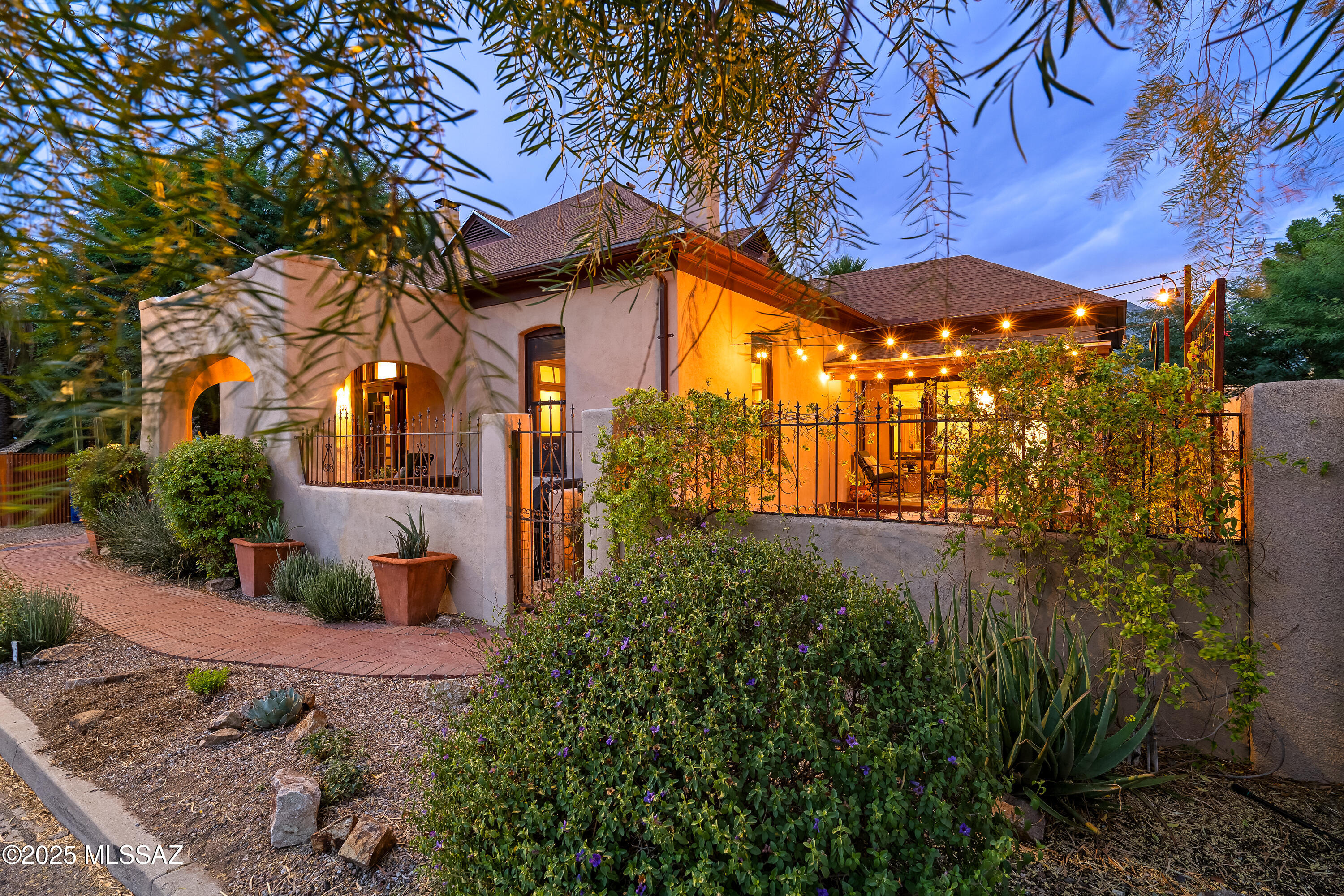 In the heart of Tucson's historic Armory Park, this home embodies all that downtown living has to offer. Extraordinarily preserved and updated, this residence was built in 1907 and remains intact with vintage hardware, hardwood floors, transom windows, and picture rails. With remarkable attention to detail, the systems of this home have been upgraded and improved without compromising the spirit of its original architecture or materials. The floor plan has been beautifully expanded with permits to accommodate a more modern lifestyle within the envelope of this historic home. Centered around an elegant zaguan, each spacious room has high ceilings, copious amounts of natural light, and the warmth of wood that has endured for over a century. Three bedrooms, each with an en-suite bathroom and generous closets, complete the private quarters while a formal living room and sun room offer flexibility and function. The uncommonly large kitchen for an older home has custom cabinets, stainless appliances, and quartz countertops. Upstairs, the expansive primary suite offers sweeping views of the Tucson Mountains, including "A" mountain. The wraparound attic offers unmatched storage for a downtown historic home. Outside the yard is inviting day or night with a water feature, custom fire pit, and low maintenance turf. Enjoy sunny mornings, or afternoon shade from the garden or covered porch. Off-street parking accommodates two vehicles and this location is just a short distance to the best dining, entertainment, and transportation in the Old Pueblo.