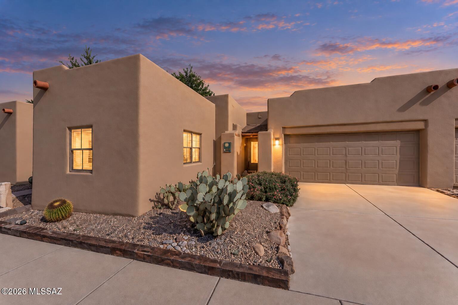 OWNED SOLAR, PARTIALLY FURNISHED & EASY LIVING IN THE SPRINGS! Enjoy the Green Valley lifestyle in this lovely 2-bedroom, 2-bath townhome with a 2-car garage, thoughtfully designed for comfortable year-round living or the perfect winter retreat. Energy savings come easy with a fully owned solar system, while recent updates include roof recoated February 2026 with transferable warranty, interior paint (2023) and exterior paint (2025). The contemporary open floor plan features ceramic tile throughout the main living areas and flows effortlessly into the kitchen, complete with stainless steel appliances, a double pantry, and a breakfast bar perfect for morning coffee or casual meals. The kitchen connects seamlessly with the dining and living areas, creating an inviting space for everyday living and entertaining. The split-bedroom floor plan provides added privacy. The spacious owner's suite features carpet flooring, a walk-in closet plus a second closet for additional storage, and an en-suite bath with a walk-in shower. The guest bedroom offers its own special touches with laminate wood flooring, a window box with sitting bench, and a double closet, while the guest bath includes a tub/shower combination. Step outside to your private backyard retreat with a covered porch, paver patio, and charming Southwest-style gate, an ideal setting to relax and enjoy Arizona's beautiful weather. Located in desirable The Springs, you'll enjoy access to Green Valley Recreation amenities along with convenient proximity to the De Anza Trail and Canoa Ranch Lake. Whether you're searching for a full-time residence, seasonal escape, or easy lock-and-leave lifestyle, this inviting home offers comfort, convenience, and the best of Southern Arizona living.