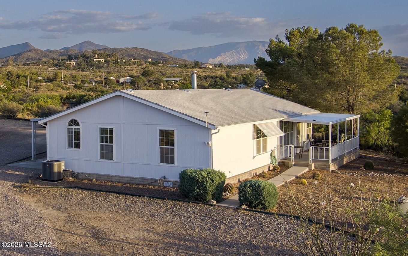 Seller will entertain offers in the range price of $300,000-$325,000. Nestled at the top of a hill with amazing views in every direction' best describes this lovely 3 bed/2 bath manufactured home on a peaceful lot in Oracle. NEW heat pump in 2022! With over 5 acres of peaceful, private country living, you will enjoy your morning coffee while watching the birds & local wildlife drinking from the water feature in the yard. Property is fully fenced and gaited, and includes 2 storage sheds and a full RV hookup. Less than 2 miles from Hwy 77, you are just a short drive to downtown Oracle, the walking trails of Oracle State Park, or all that NW Tucson/Oro Valley have to offer (restaurants, shopping, hospital & movie theatre). You will fall in love with this home & area when you see it!