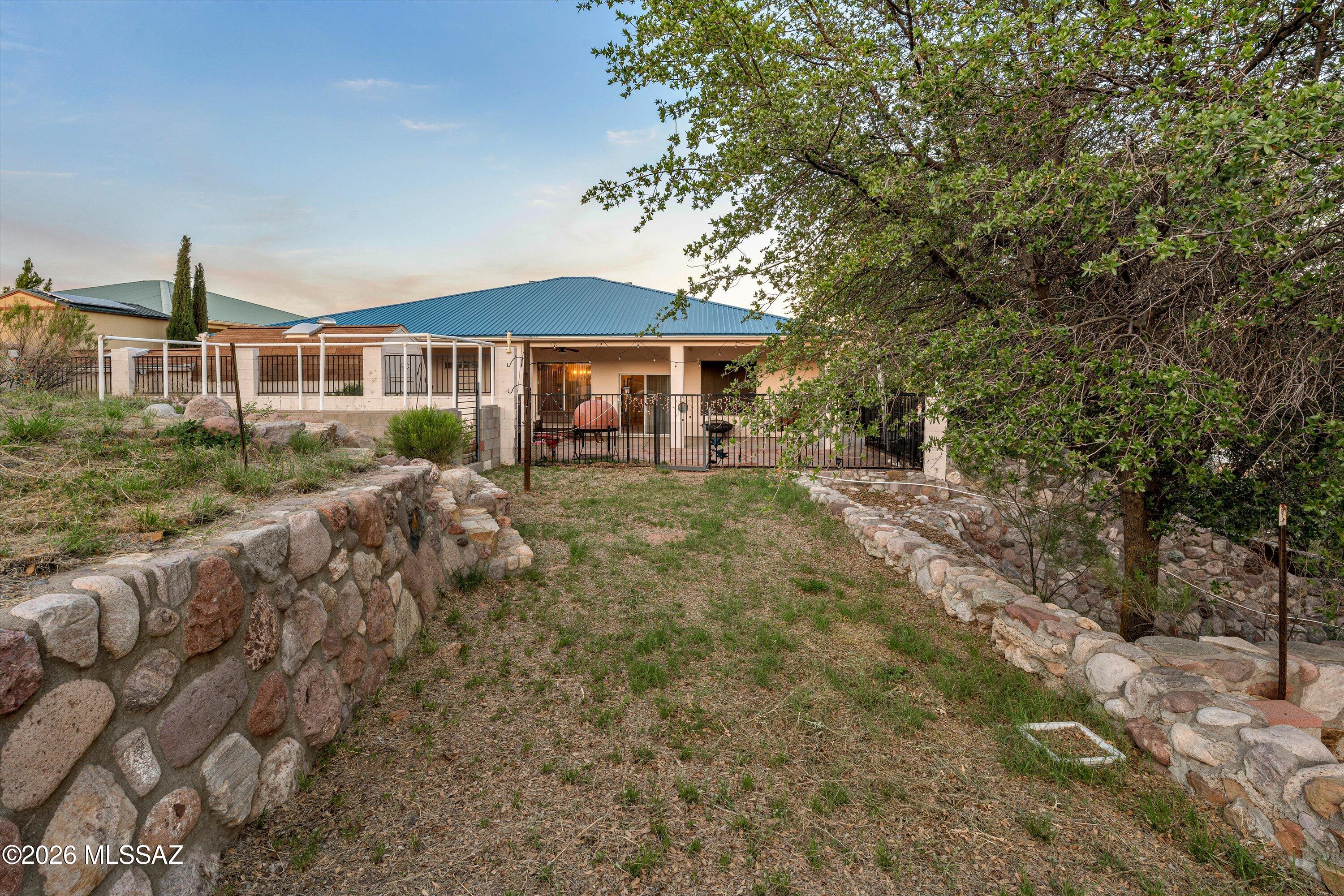 Welcome home to 1224 N Caminito Rd, a truly stunning Oracle gem offering an unparalleled blend of tranquil rural living and modern comfort. Set against the majestic backdrop of the Santa Catalina Mountains, this property provides panoramic views and a sense of escape just a convenient drive from the amenities of Tucson.

This spacious and updated home features 3 bedrooms and 2 baths, providing ample space for relaxation and enjoyment. Step inside to discover a bright and inviting interior, where tasteful finishes meet functional design. The living areas are perfect for entertaining, with a cozy fireplace adding warmth and ambiance. The well-appointed kitchen boasts sleek appliances and plenty of counter space, making meal preparation a delight. Outside, you'll find your private oasis on a generous 1.82-acre lot that offers riprap pathways and two sheds! The fenced in patio has a professionally installed snake fence, allowing you to fully enjoy spectacular Arizona sunsets from your patio or host gatherings under the stars. The expansive outdoor space offers endless possibilities for gardening, recreation, or simply unwinding in nature's embrace. With private and mature landscaping, this property truly feels like a turnkey retreat.

For those seeking a move-in ready experience, many of the home's furnishings are negotiable, offering an effortless transition into your new lifestyle. This is more than just a home; it's an opportunity to embrace the serene and picturesque lifestyle that Oracle offers. Don't miss your chance to own this piece of Arizona paradise.