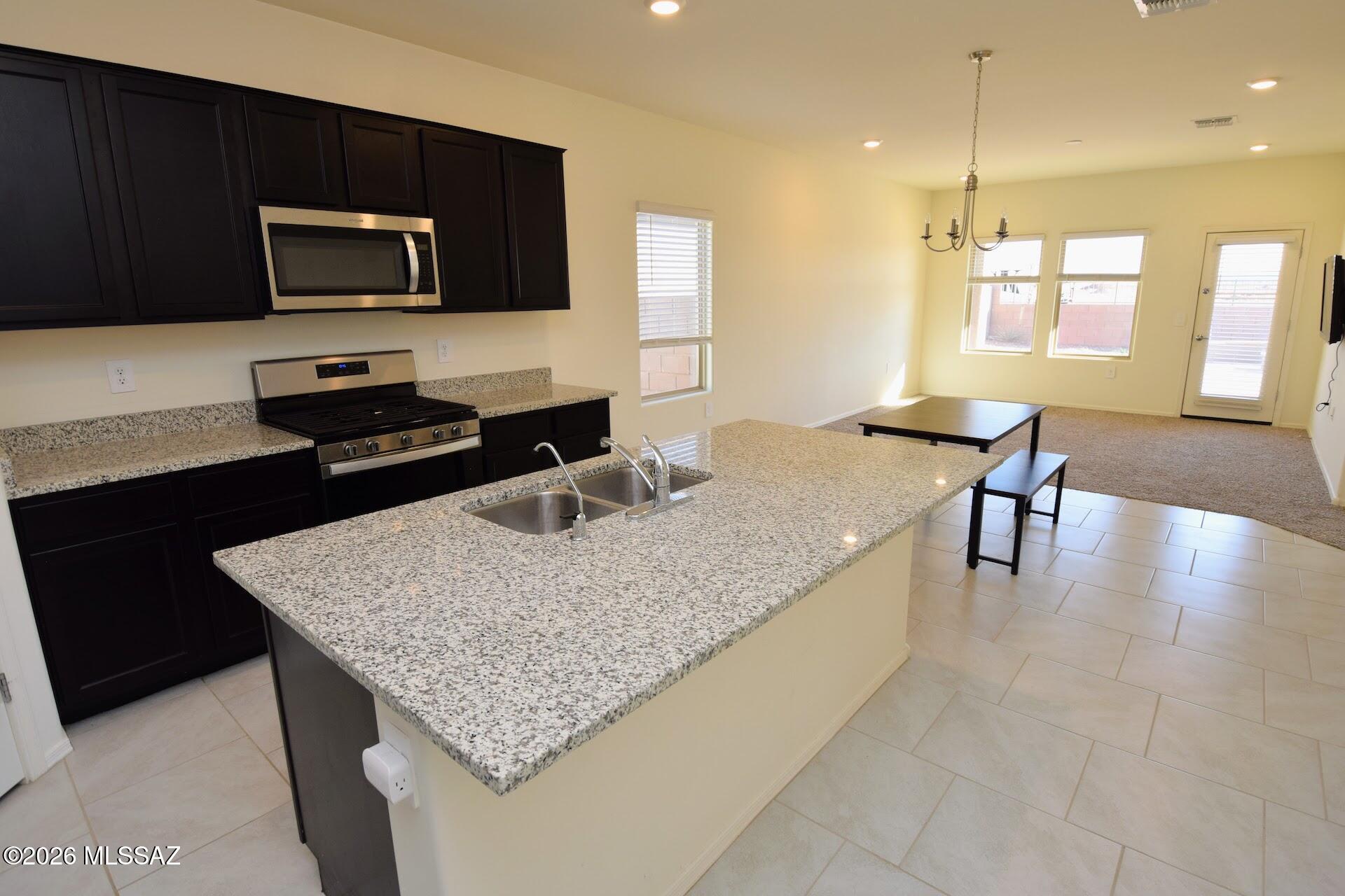 NW Marana Saguaro Bloom 4 Bed 2 Bath built in 2021. 1569 SQ FT. Open-concept floor plan with all the amenities a new construction home comes with. The kitchen has a breakfast bar, gas stove, walk-in pantry, and all stainless steel appliances. The primary suite is spacious and has great natural light from the 2 south-facing windows. The primary bath has a dual sink vanity, a walk-in shower, built-in storage, and a huge walk-in closet. The backyard has a covered patio as well as a flagstone seating area with a bench and fire-pit. Full-size washer/dryer. This home came built with numerous modern and energy-efficiency features, an alarm system, and a tankless water heater. This home is offered as NON-SMOKING. Pets are subject to owner approval.