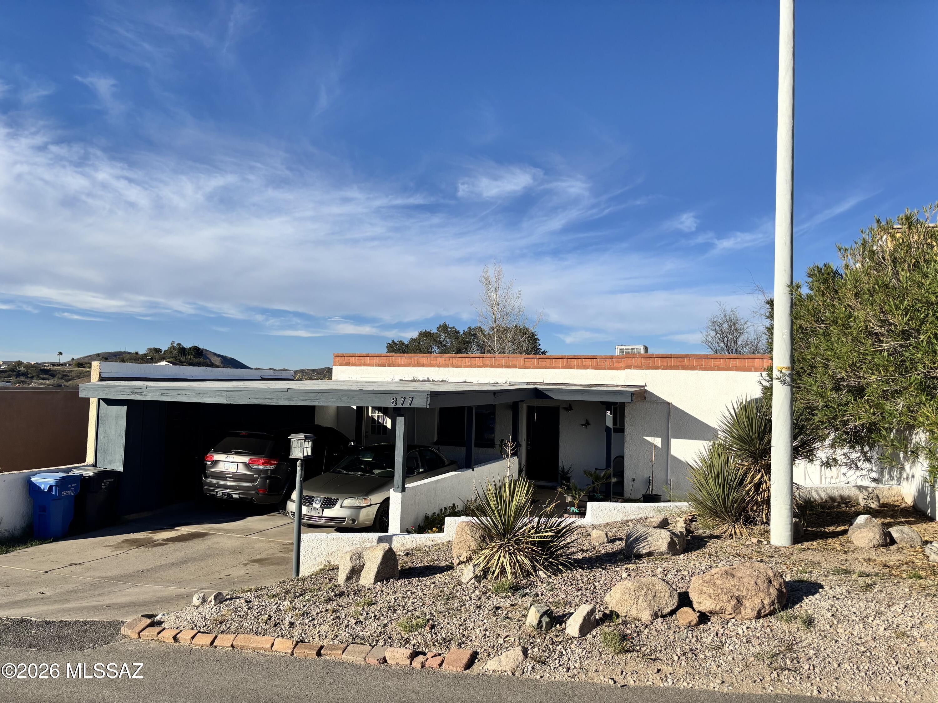 A single level 2BD/2BA townhome in Rancho Grande, where 1,205 sq ft all tile flooring keeps life simple, beautiful, and low maintenance. Morning light fills the living and dining spaces, opening to a covered patio made for slow coffee moments and peaceful evenings. The kitchen's features a gas range inviting real cooking, while both bathrooms offer clean, comfortable and  practical layouts. Framed by mountain and residential views, North/South exposure, and block-stucco fencing, the home feels private yet connected. With two covered parking spaces and NO HOA  this is effortless living with a touch of serenity.