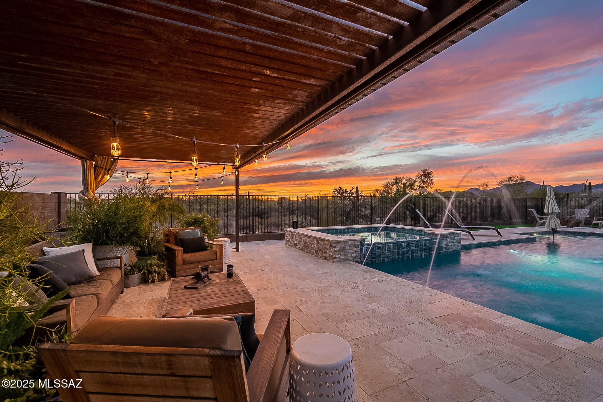 True Indoor Outdoor Resort Style Living Oversized 40x16 Salt Water Pool and Spa!! One of a kind opportunity to own in one of Oro Valley's newest and most desirable communities. This home sits on a Saguaro studded private lot just under 1 acre (0.94) with Catalina and Tortilita mountain views as well as a view of Sombrero Peak. The expansive backyard is entered from the home by an open corner sliding glass door the provides the perfect setting for large gatherings. Travertine throughout the entire backyard plus large turf area along with a huge cabana and covered patio sets the tone for all your outdoor entertainment. Pool has large Baja ledge with additional seat along the west end. Agent/Owner Inside the gourmet kitchen you will find a massive waterfall edge quartz countertop island with plenty of cabinets for all of your kitchen items and modern tile backsplash to the ceiling. Kitchen stove and oven plumbed for gas where the current electric appliances exist for easy switch over if desired. This is one of the most open floor plans with two living areas accented with soaring 10 ft ceilings and engineered hardwood floors. The open corner slider is 15'x10' allowing you to open your living room to the travertine covered patio bringing the backyard right inside your home. Plantation shutters added to all windows for a timeless addition that cannot be beat. 

The Master Suite is grande overlooking the pool area with plenty of room for a seating area. Master bath has garden style tub with separate shower and two vanities providing a comfortable and elegant setting to start each day. Walk right through to find the unbelievable his and hers master closet with more than ample space. 

Additional bedrooms are split from the Master two of which are ensuite with their own full bathrooms and the third was added with hall bath across upgraded with beautiful tiled walk-in shower so each room is paired with a full bathroom allowing for families to have full comfort and also provide for true privacy in guest quarters. 

Third car garage has upgraded leveled concrete finished floor for the perfect office space or additional storage room. 30 amp electrical and dedicated 20 amp as well. Main garage has shelving on both sides along with water softener, tankless water heater and plumbing for sink. 

Front yard has over 30k in upgraded landscaping with irrigation and lighting. Backyard overlooks open desert lot that could be expanded on with additional landscaping. Overall over 200k in outdoor upgrades. 

This home truly has everything nestled in a private yet neighborly gated community with only 44 private residences. HOA includes trash and recycling for convenience and road was just repaved throughout the community. Seller is offering flooring and paint credit at closing.